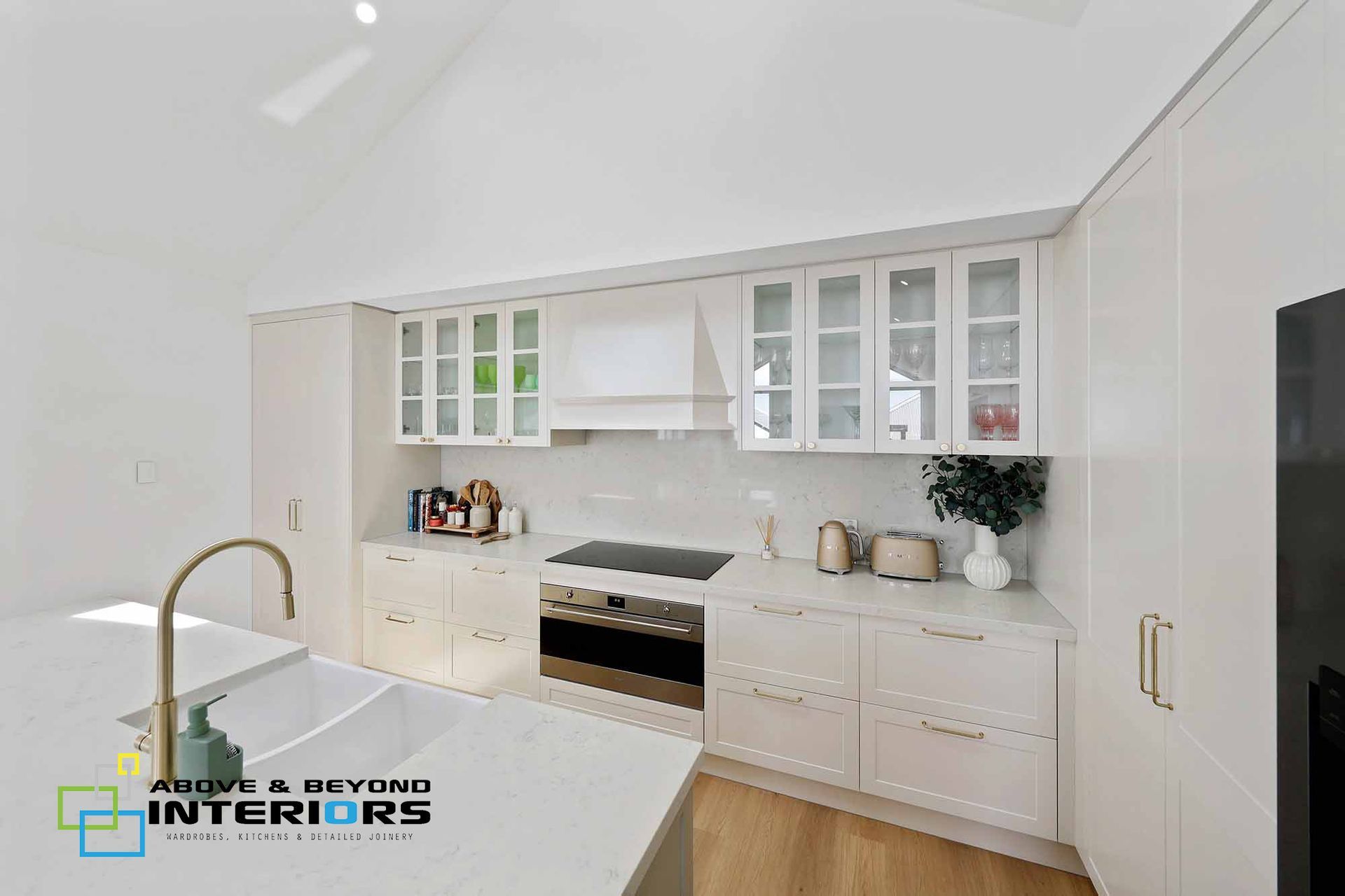 Bright White Kitchen with Brass Fixtures — Above & Beyond Interiors in Smeaton Grange, NSW
