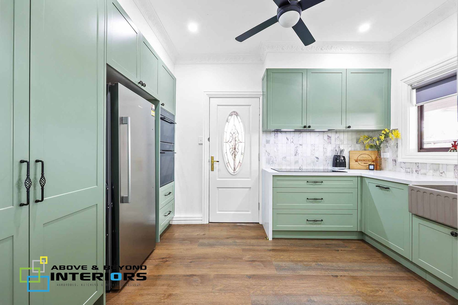 Bright Mint-Green Kitchen with White Door — Above & Beyond Interiors in Smeaton Grange, NSW