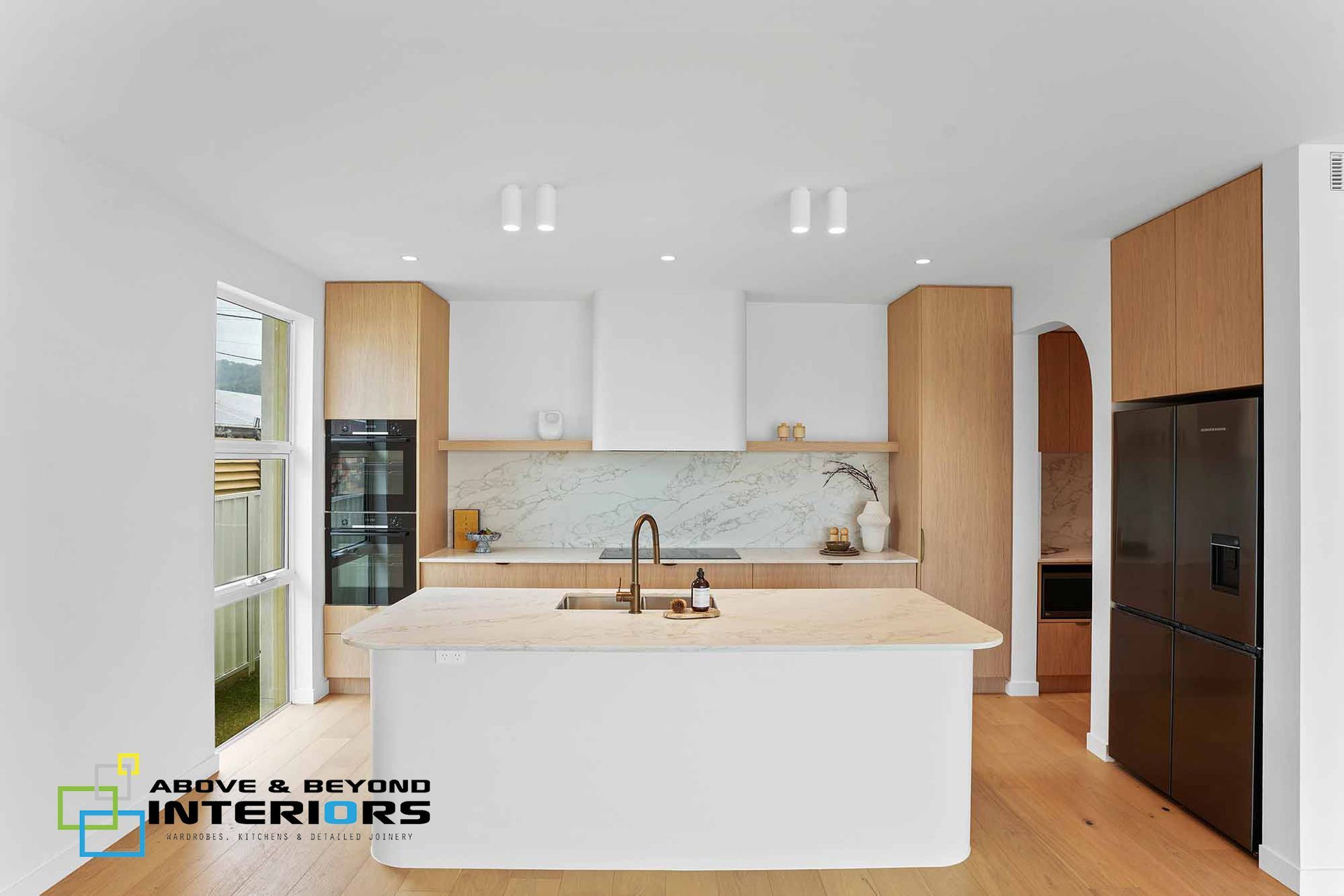 Bright Modern Kitchen with White Island — Above & Beyond Interiors in Smeaton Grange, NSW