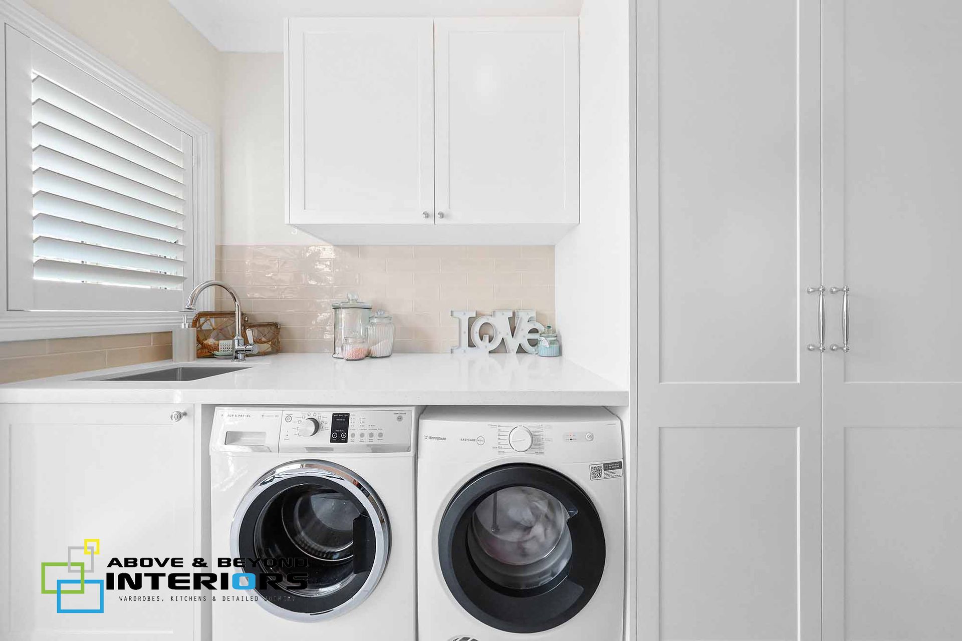 Bright Laundry Room with White Cabinets — Above & Beyond Interiors in Smeaton Grange, NSW