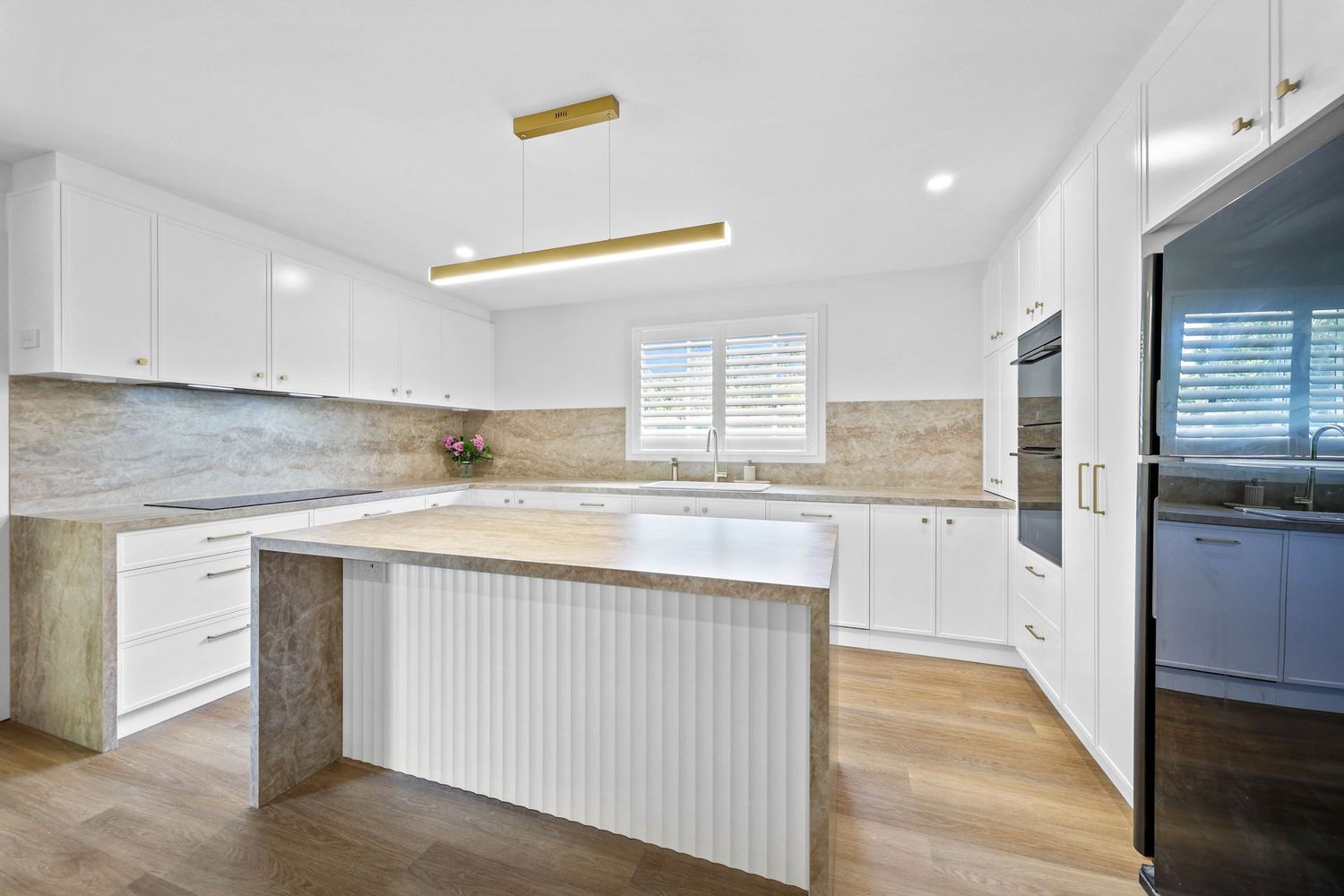 Bright White Modern Kitchen With Island — Above & Beyond Interiors in Smeaton Grange, NSW