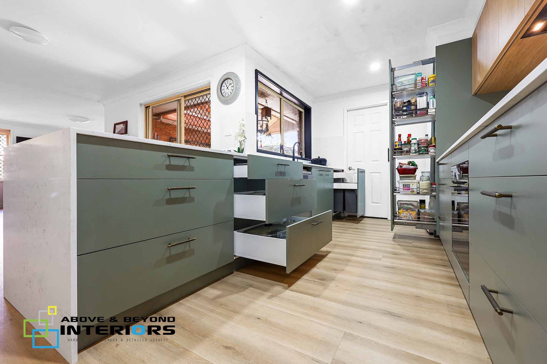 Modern Office Kitchen with Glass-Front Cabinets — Above & Beyond Interiors in Smeaton Grange, NSW