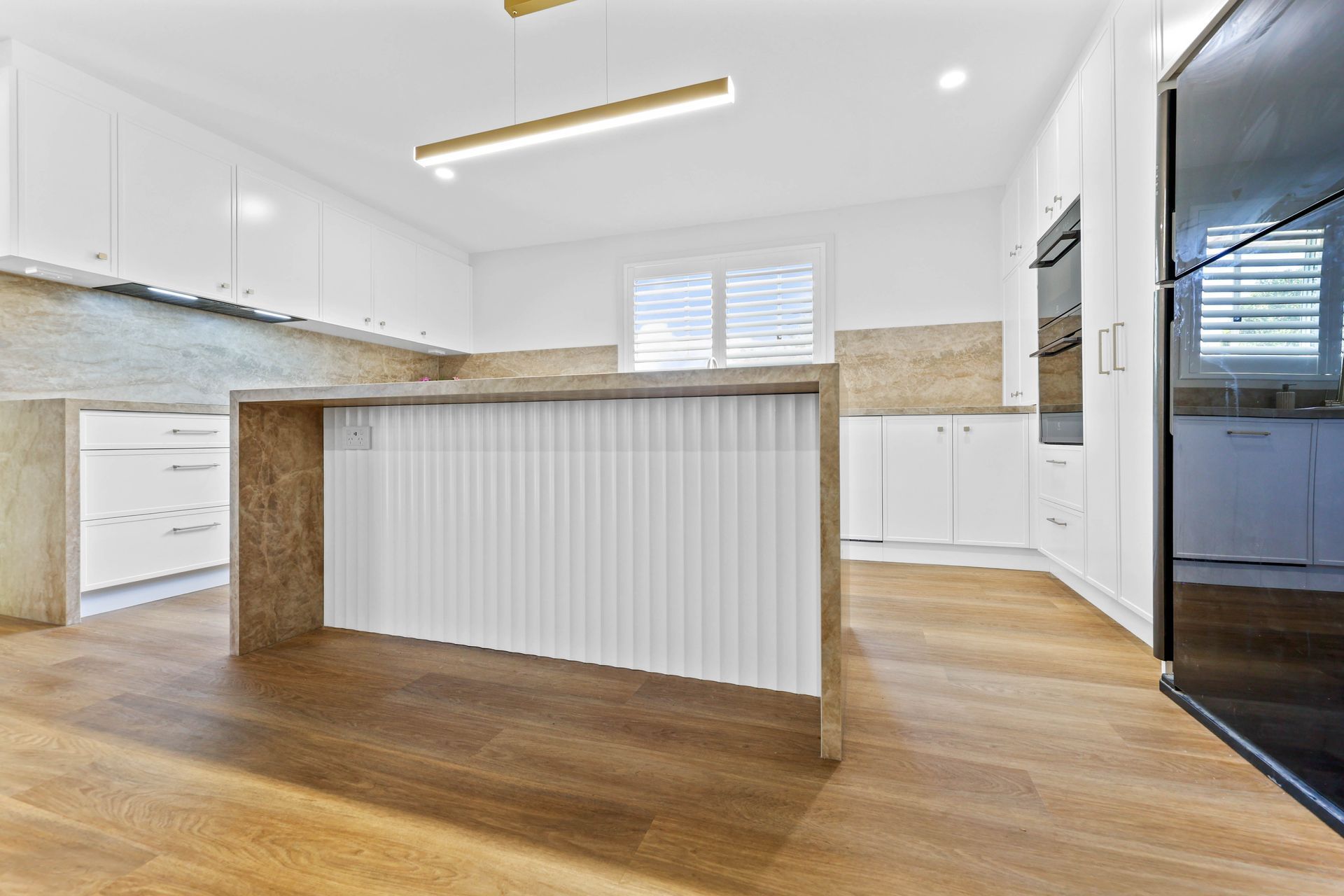 Bright Modern Kitchen With White Cabinets — Above & Beyond Interiors in Smeaton Grange, NSW