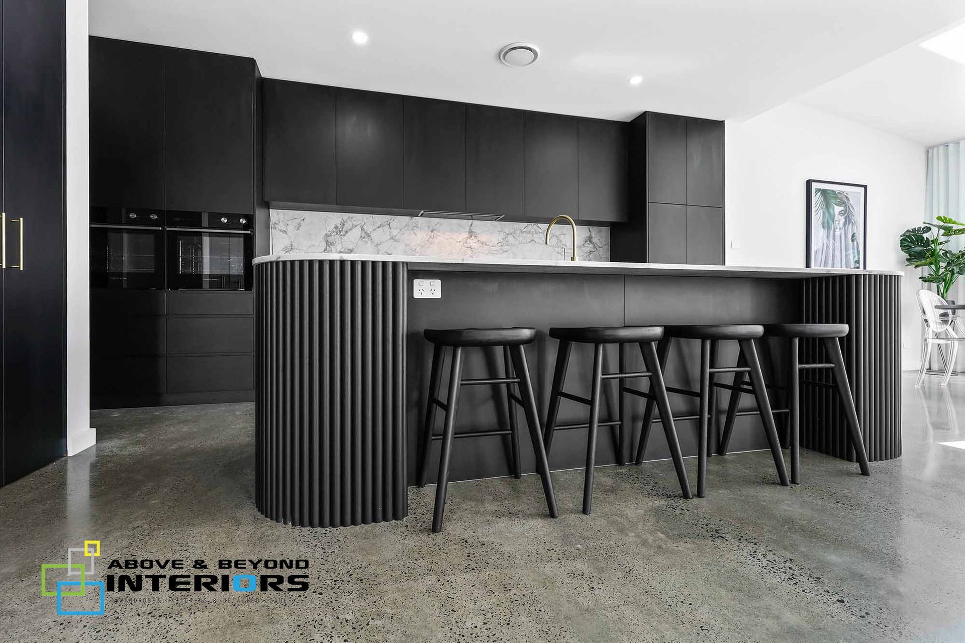 Modern Black Kitchen with Marble Island, Bar Stools, and Gray Concrete Floor — Above & Beyond Interiors in Smeaton Grange, NSW