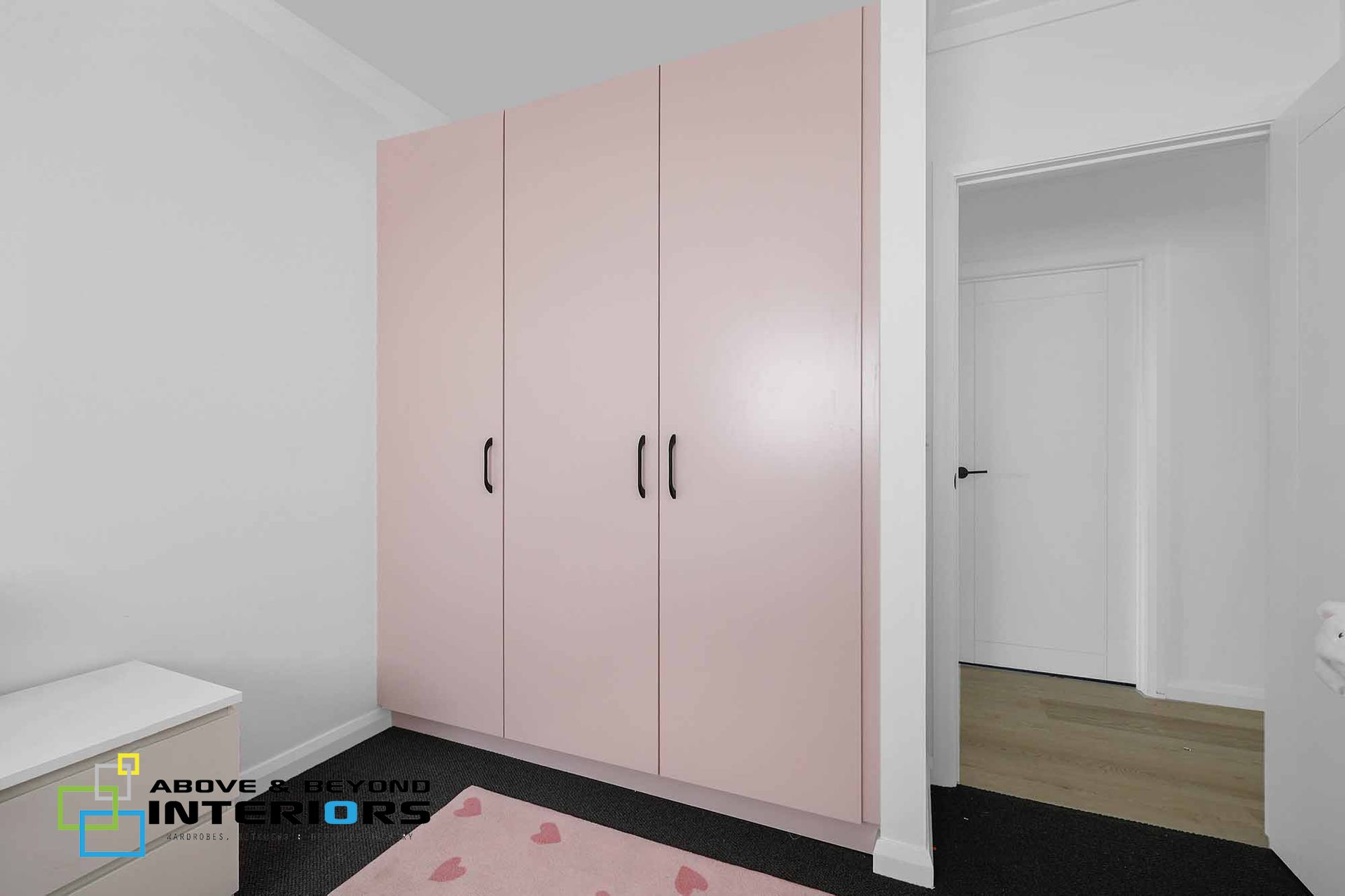 A Bedroom with A Pink Wardrobe — Above & Beyond Interiors in Smeaton Grange, NSW