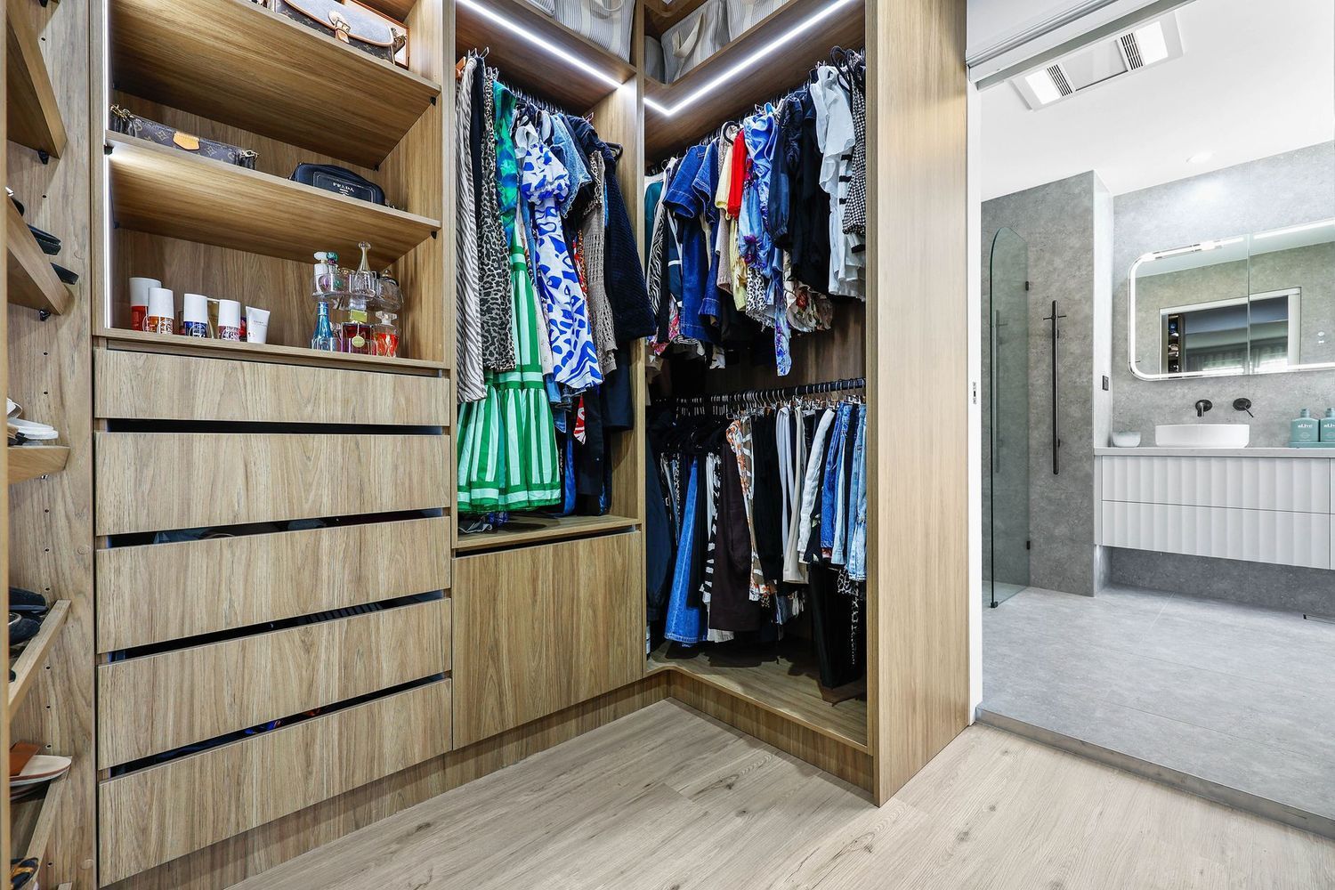 Open Walk-in Closet With Wood Shelving — Above & Beyond Interiors in Smeaton Grange, NSW