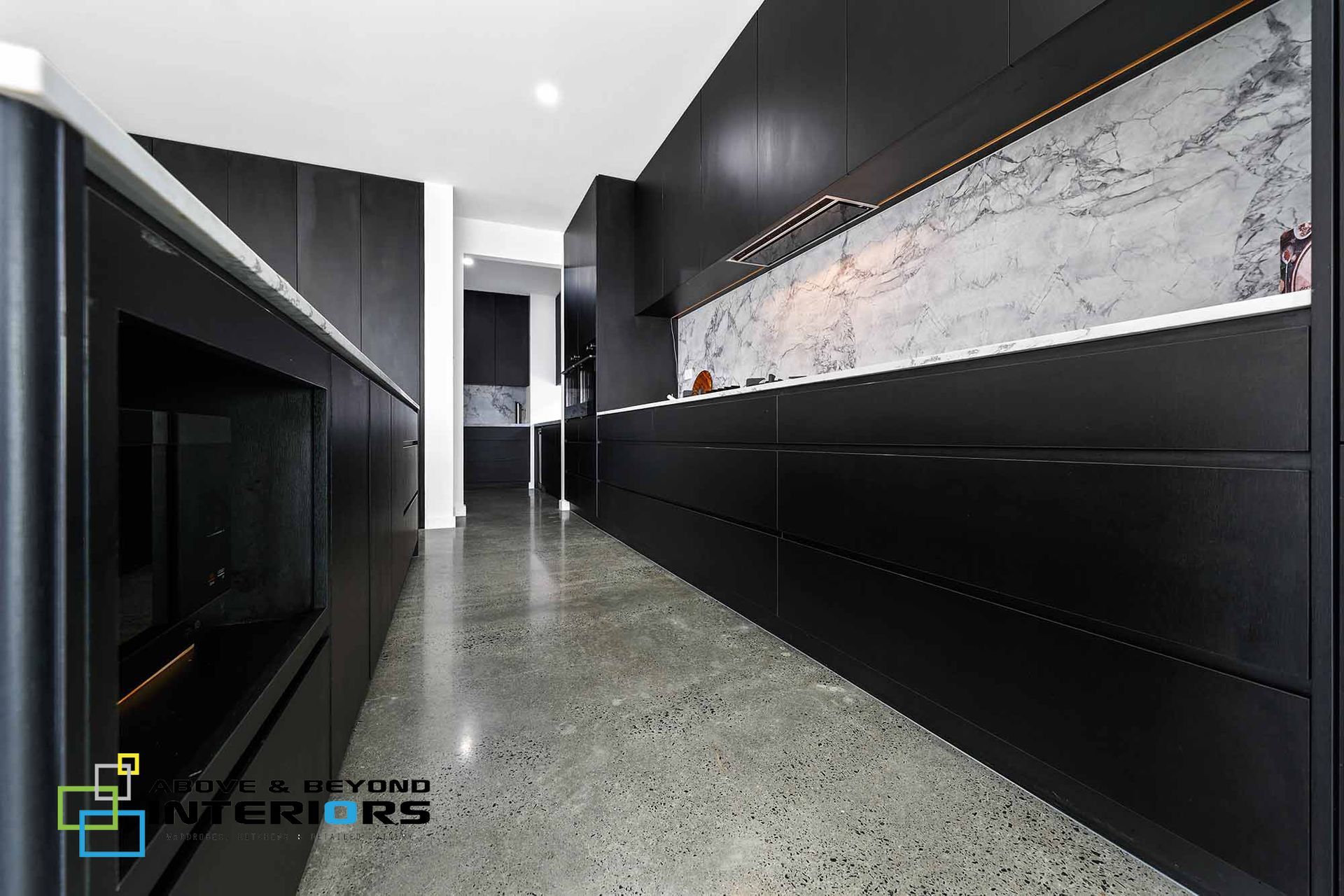Modern Black Kitchen with Glossy Cabinets — Above & Beyond Interiors in Smeaton Grange, NSW