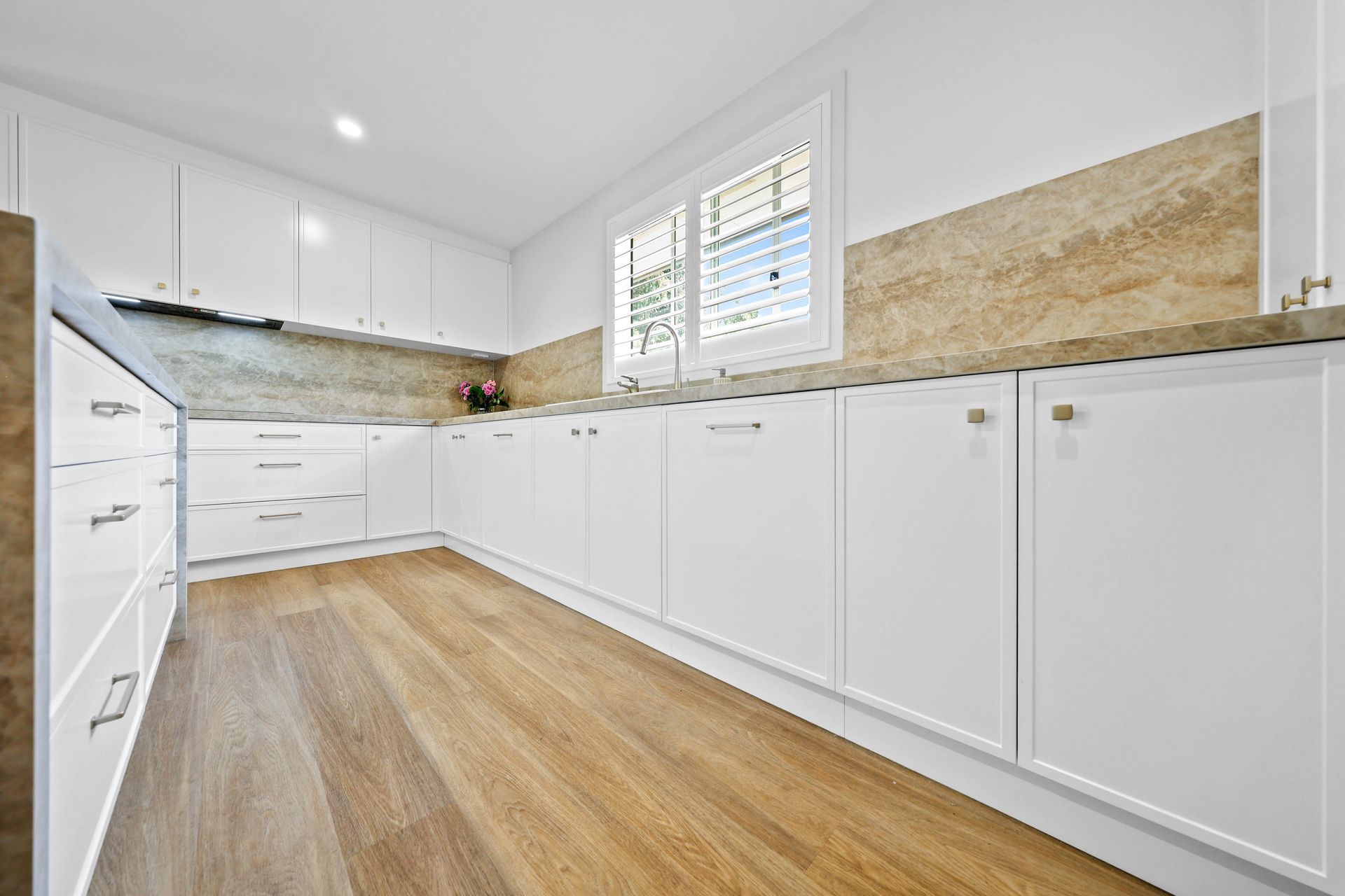 Bright Modern Kitchen With White Cabinets — Above & Beyond Interiors in Smeaton Grange, NSW