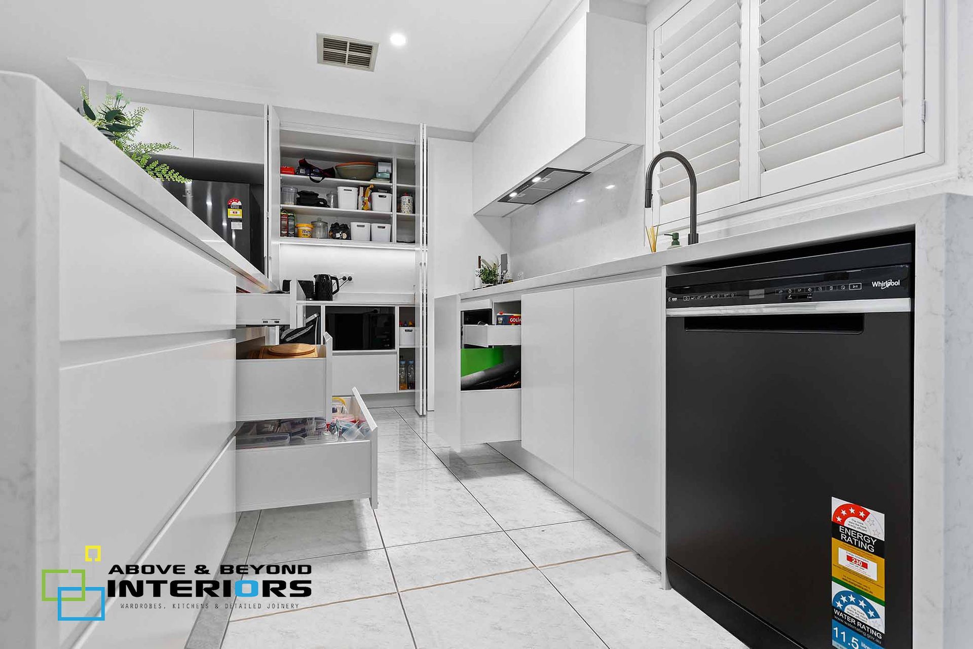 Modern White Kitchen with Black Appliances, and Tiled Floor — Above & Beyond Interiors in Smeaton Grange, NSW