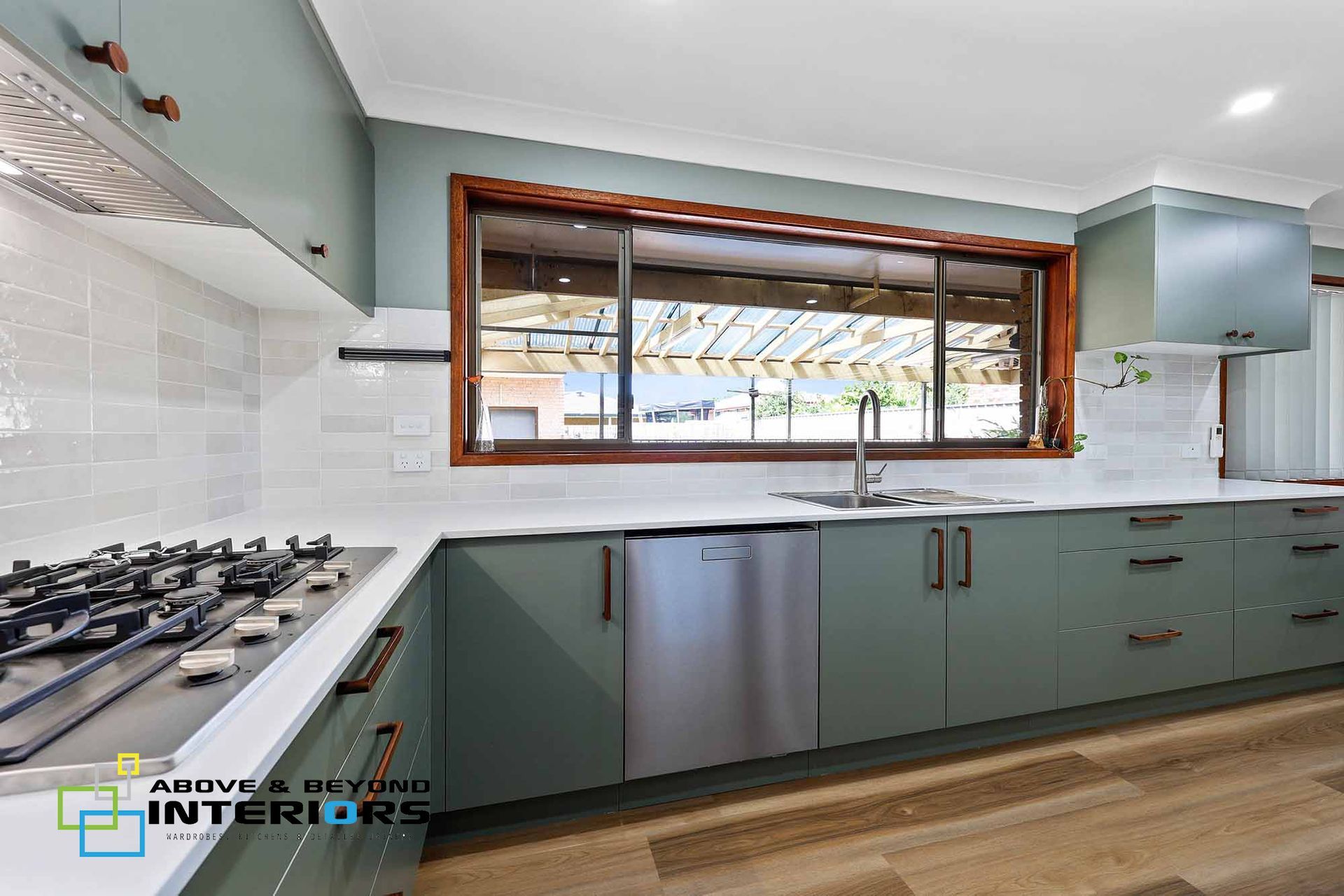 Modern Kitchen with Teal Cabinets — Above & Beyond Interiors in Smeaton Grange, NSW
