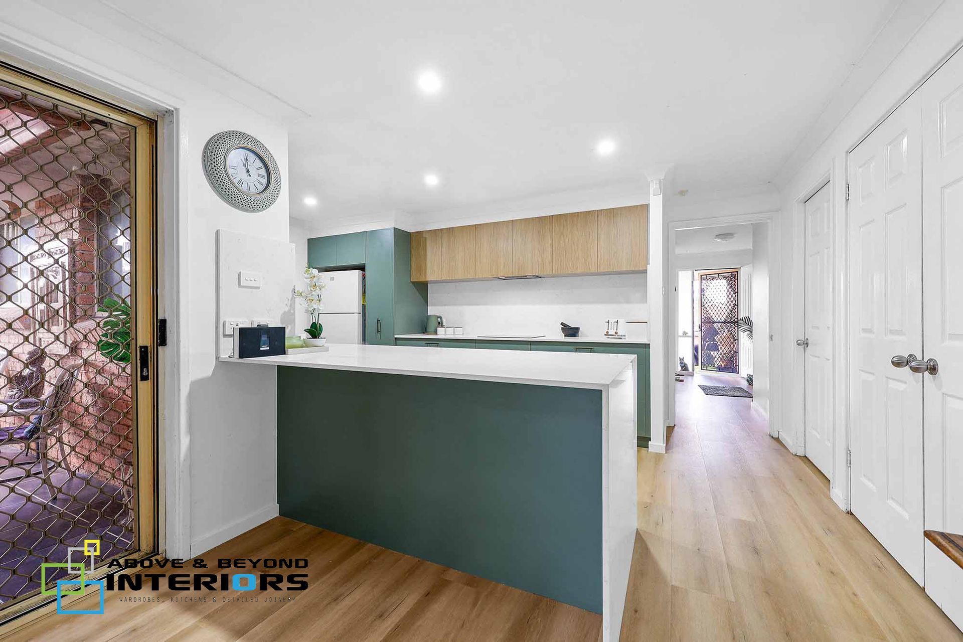 Bright Kitchen with Green Island, and White Cabinets — Above & Beyond Interiors in Smeaton Grange, NSW
