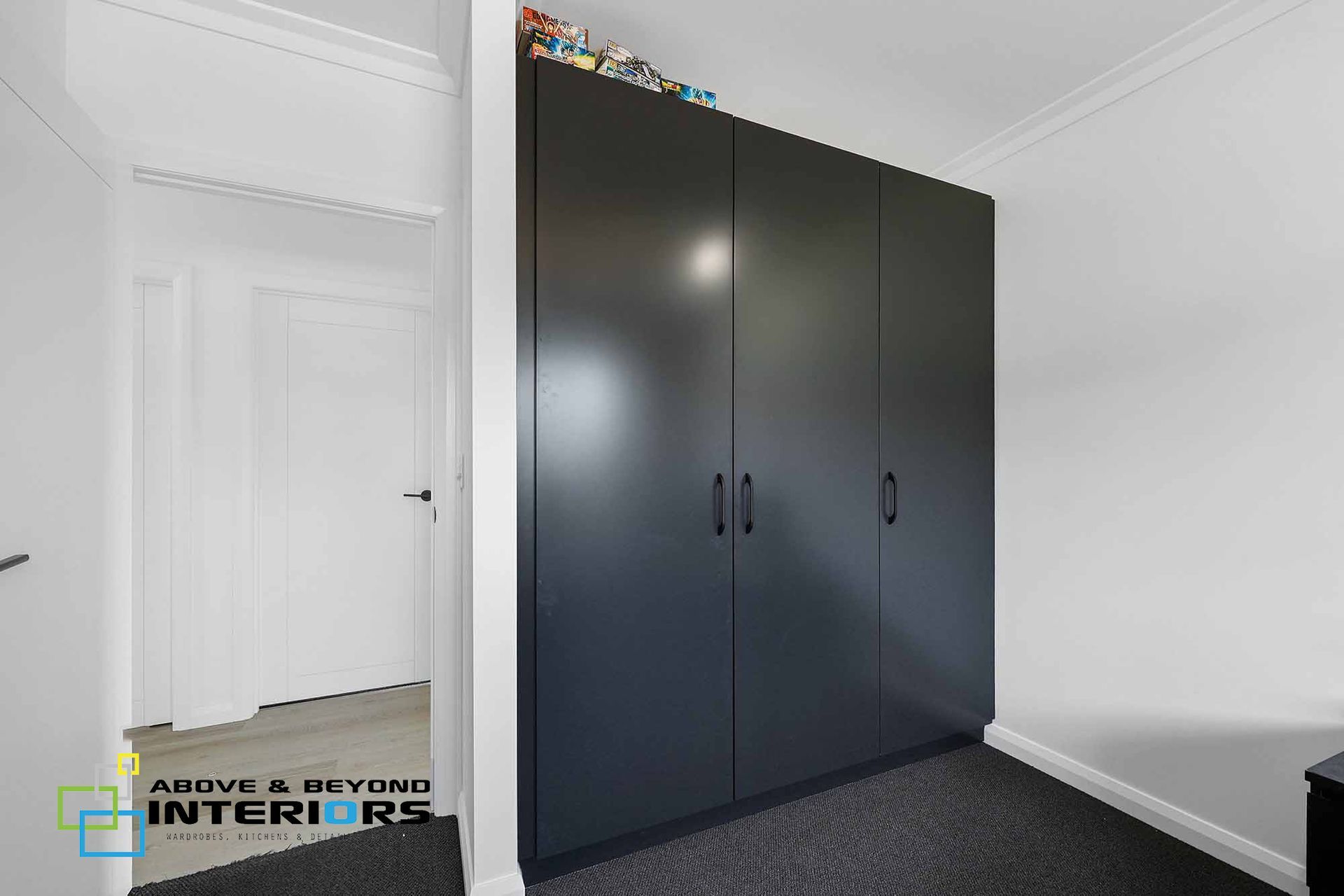 Interior Room with Large Black Wardrobe Cabinets — Above & Beyond Interiors in Smeaton Grange, NSW