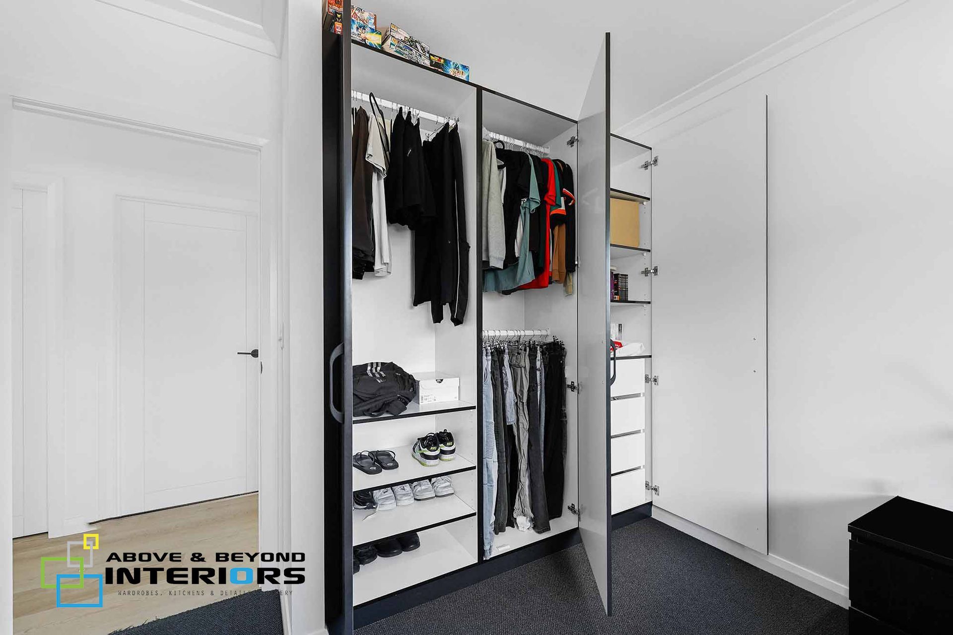 Open Closet with Hanging Clothes, Shelves, and Folded Items — Above & Beyond Interiors in Smeaton Grange, NSW