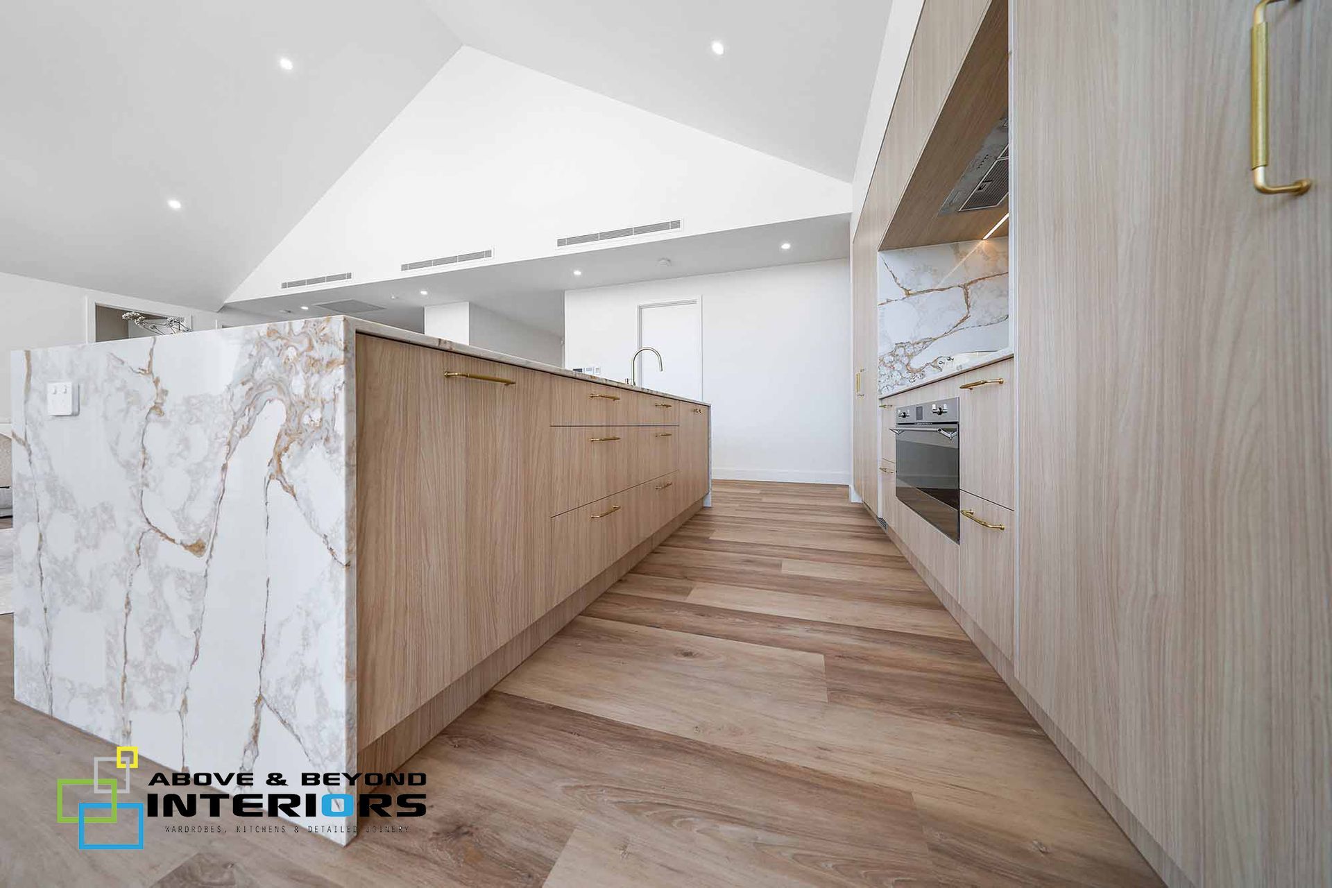 Modern Kitchen with Wood Cabinetry — Above & Beyond Interiors in Smeaton Grange, NSW