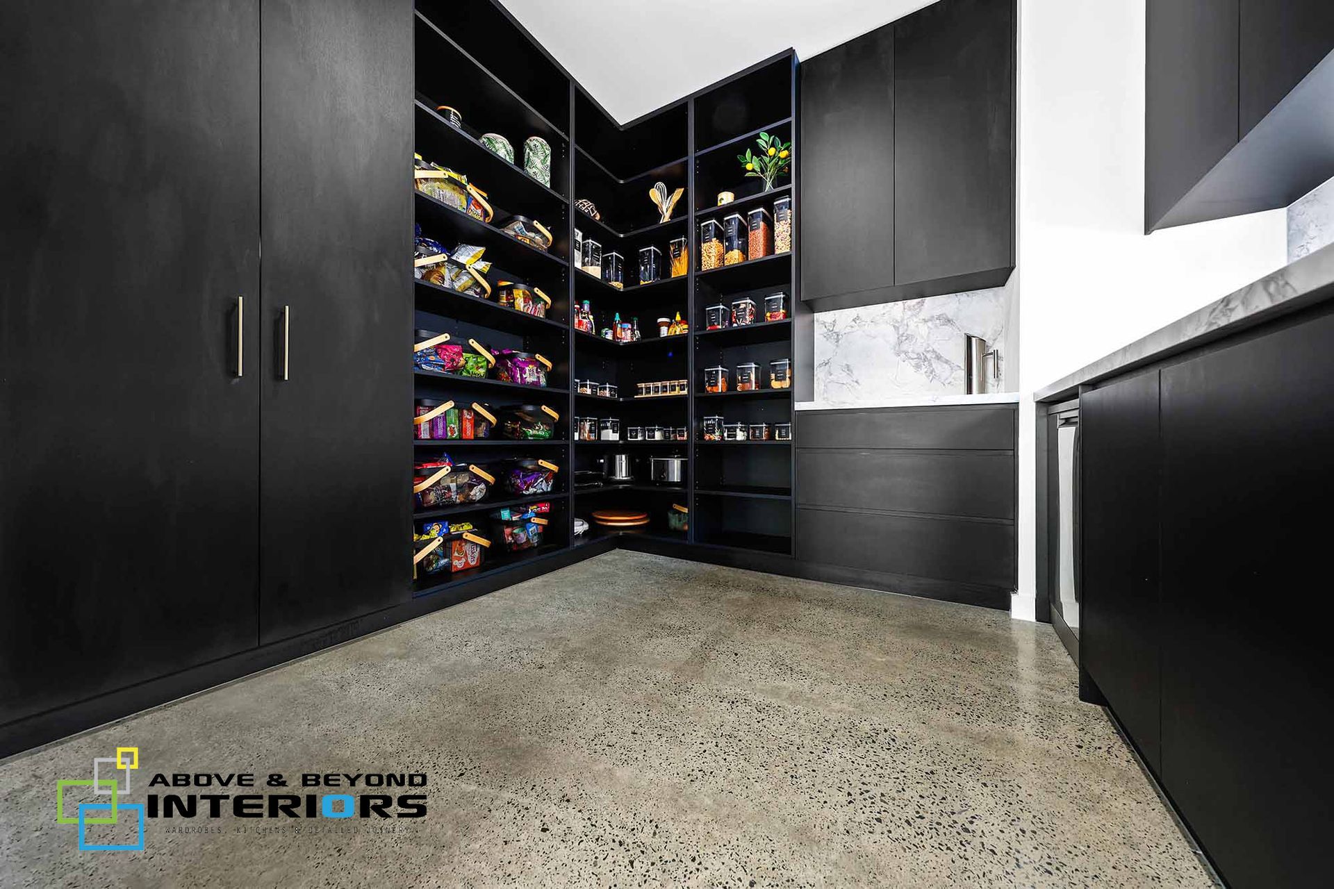 Black Pantry with Open Corner Shelves Stocked — Above & Beyond Interiors in Smeaton Grange, NSW