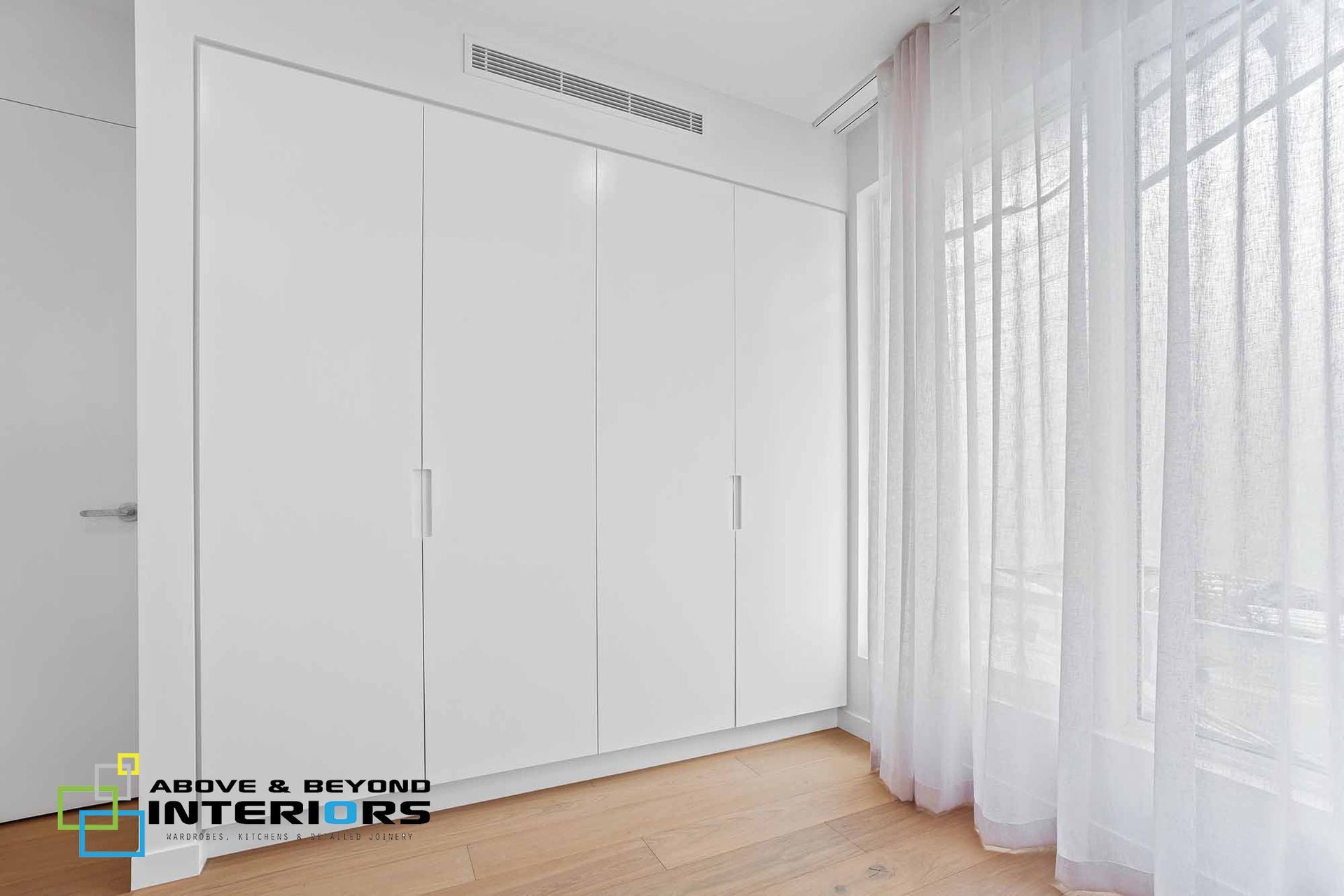Minimal White Bedroom with Built-In Wardrobes — Above & Beyond Interiors in Smeaton Grange, NSW