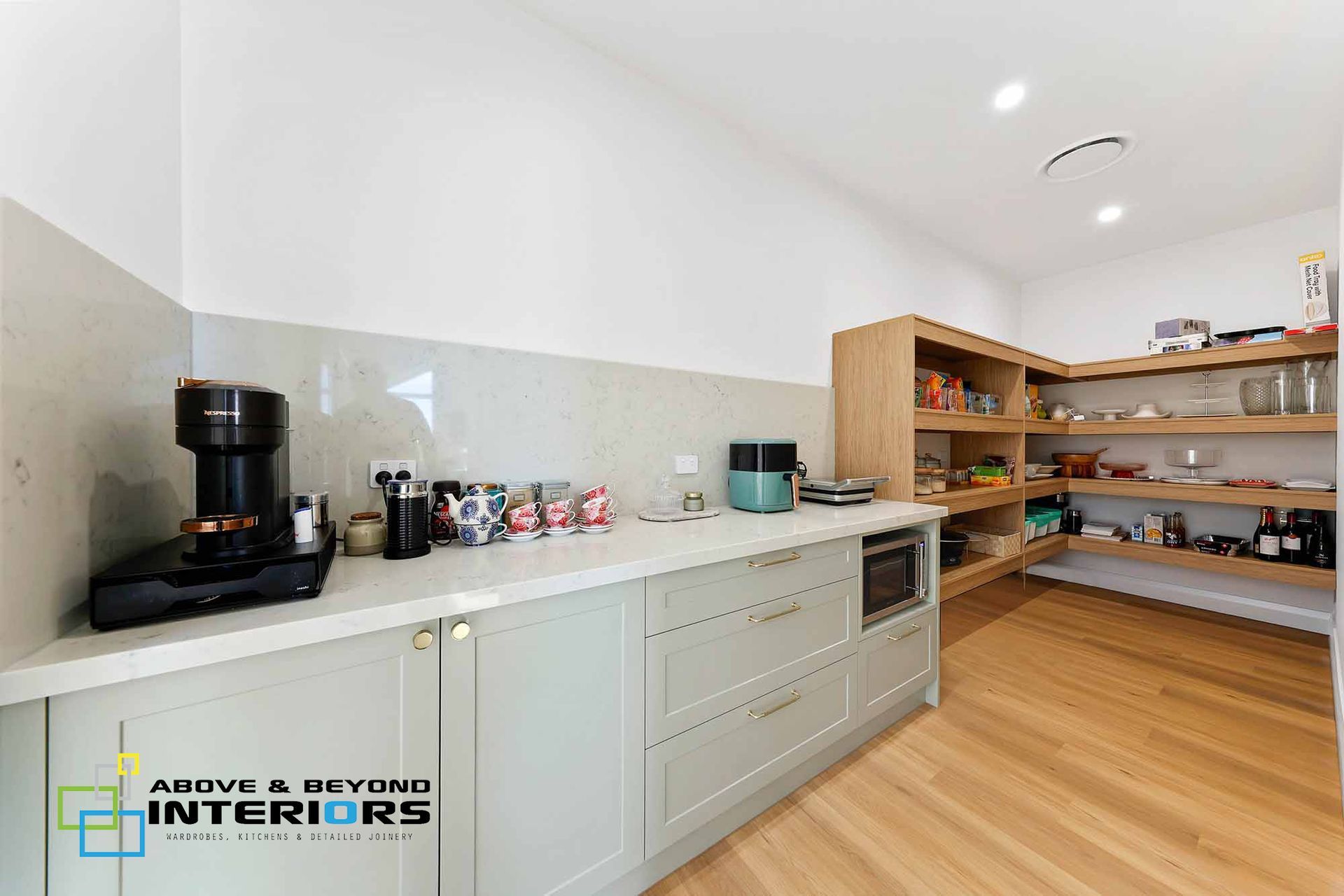 Modern Kitchen with White Cabinets and Wood Countertops — Above & Beyond Interiors in Smeaton Grange, NSW