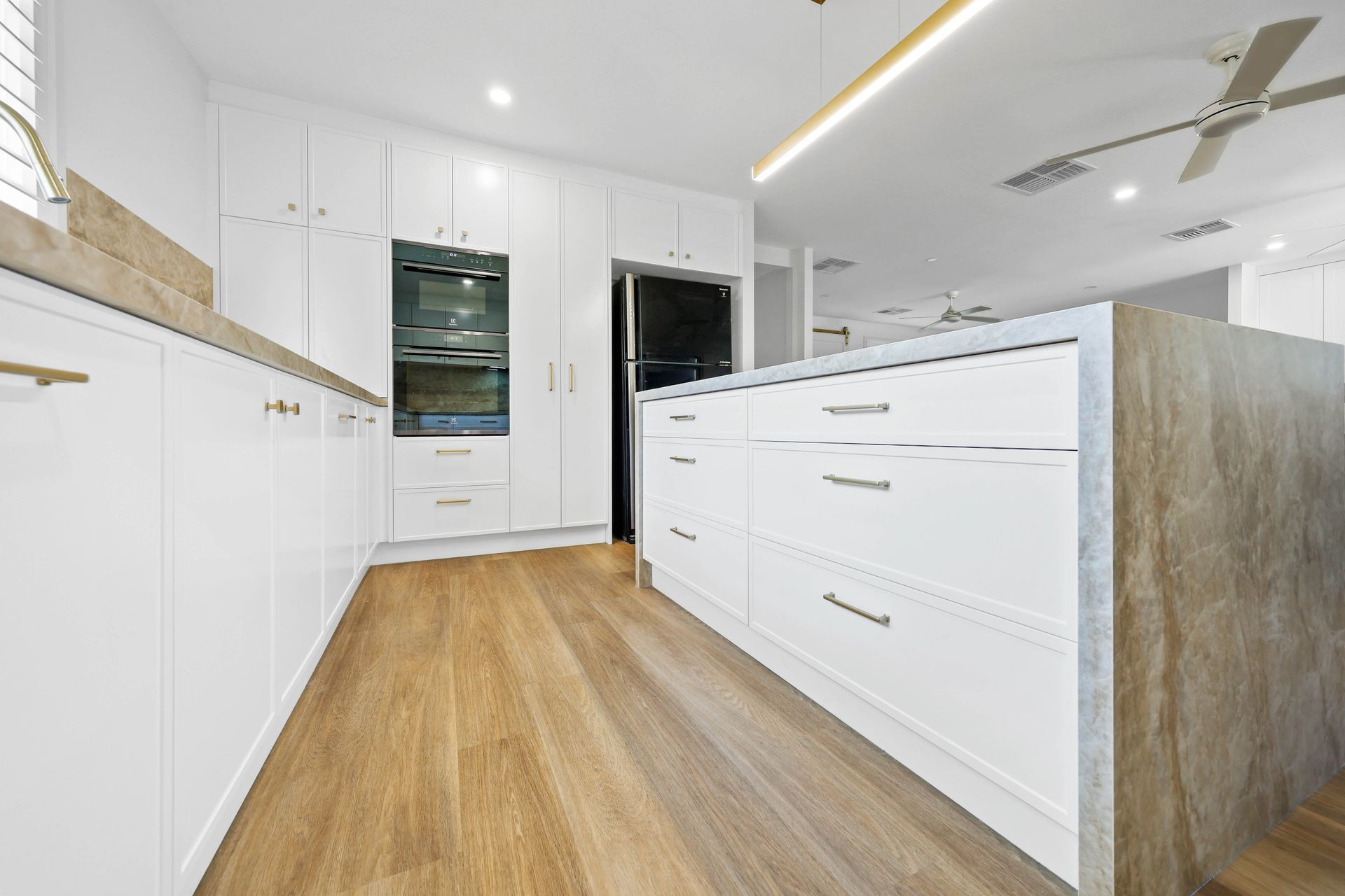 Bright Modern Kitchen With White Cabinets — Above & Beyond Interiors in Smeaton Grange, NSW