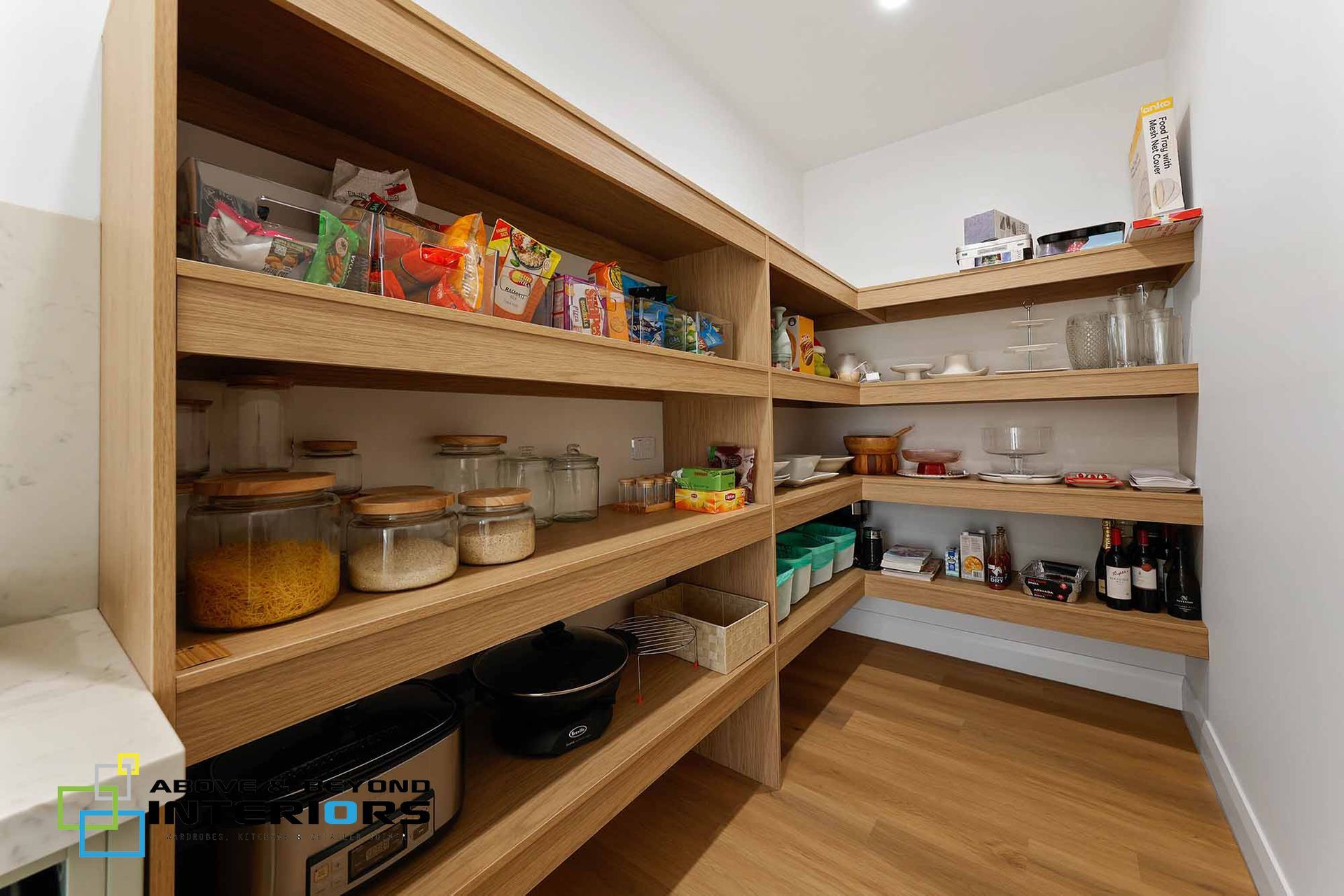 Walk-In Pantry with Wooden Shelves Stocked with Jars — Above & Beyond Interiors in Smeaton Grange, NSW