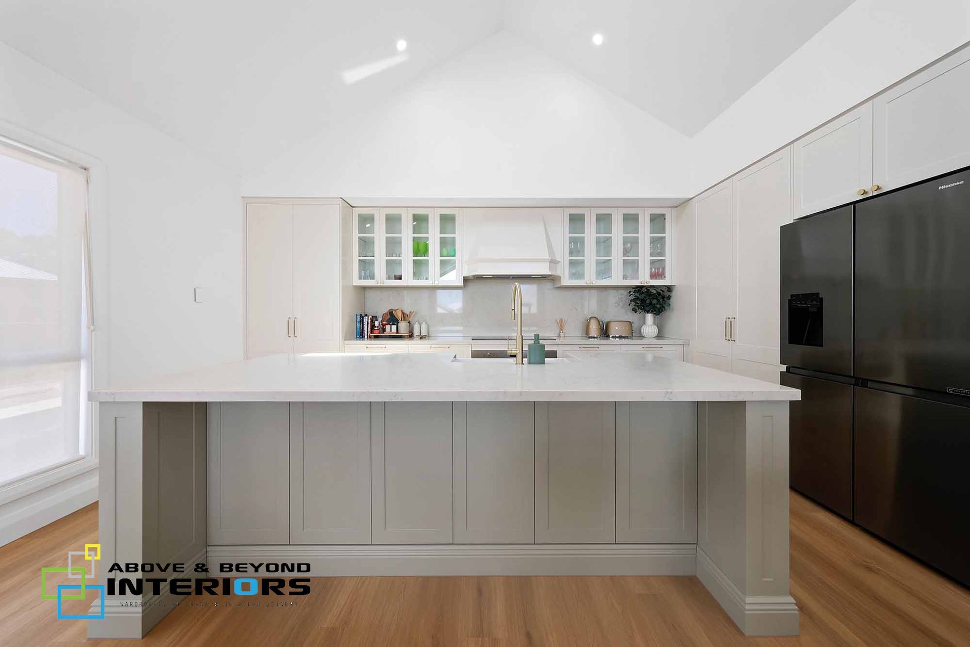 Bright White Modern Kitchen with Gray Cabinetry, Glass-Front Cabinets, and Black Refrigerator — Above & Beyond Interiors in Smeaton Grange, NSW