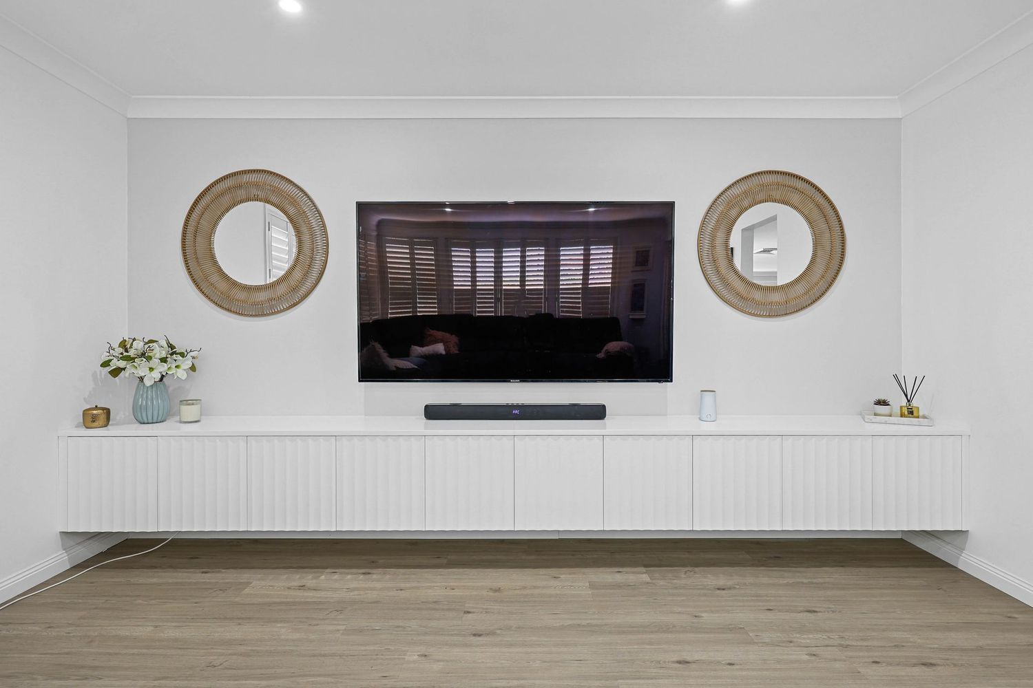 Minimalist Living Room Wall With a Mounted TV — Above & Beyond Interiors in Smeaton Grange, NSW