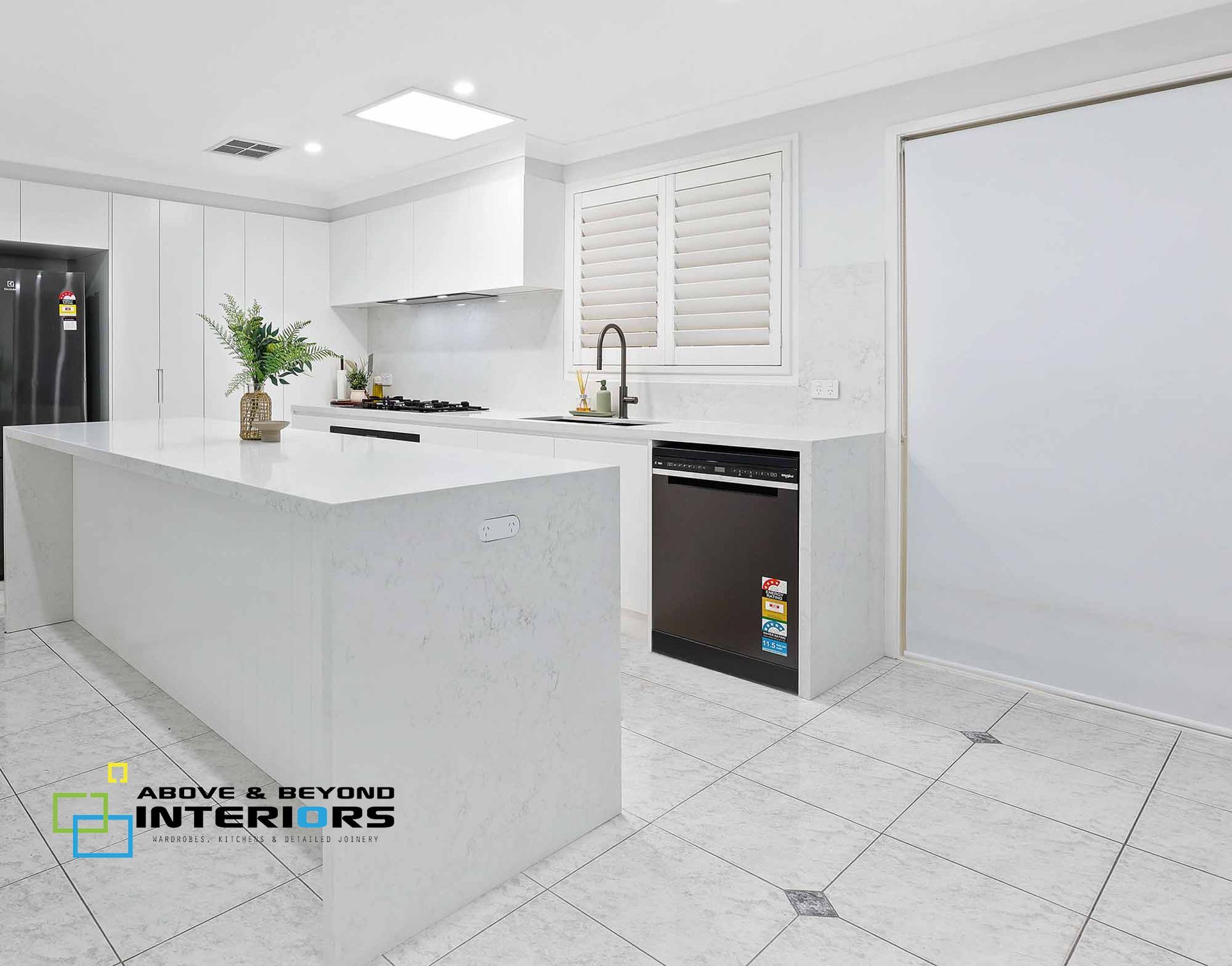 Bright White Modern Kitchen with Black Appliances, and Tiled Floor — Above & Beyond Interiors in Smeaton Grange, NSW
