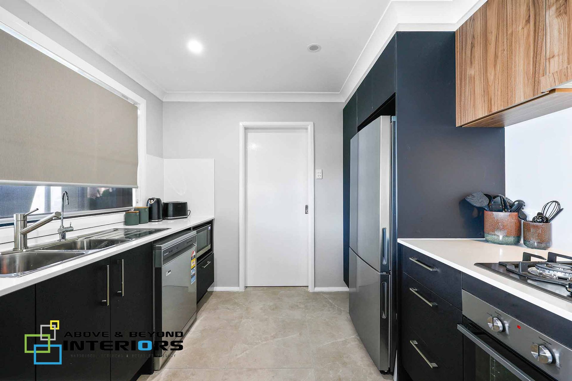 Modern Kitchen with Dark Cabinets — Above & Beyond Interiors in Smeaton Grange, NSW