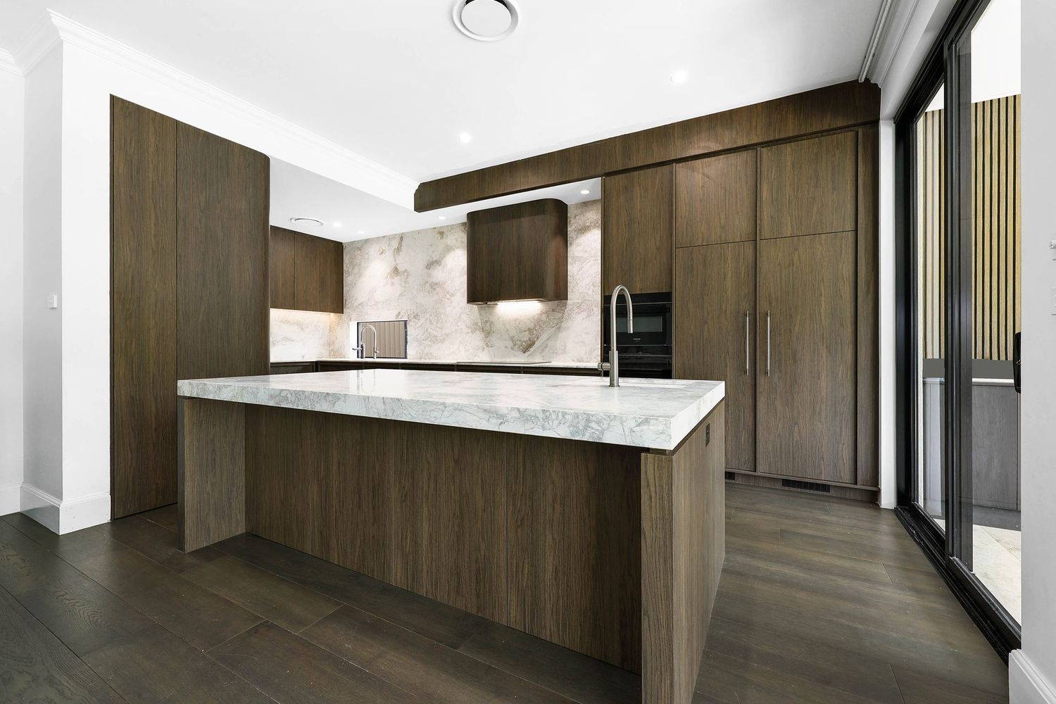 Modern Kitchen With Dark Wood Cabinets — Above & Beyond Interiors in Smeaton Grange, NSW