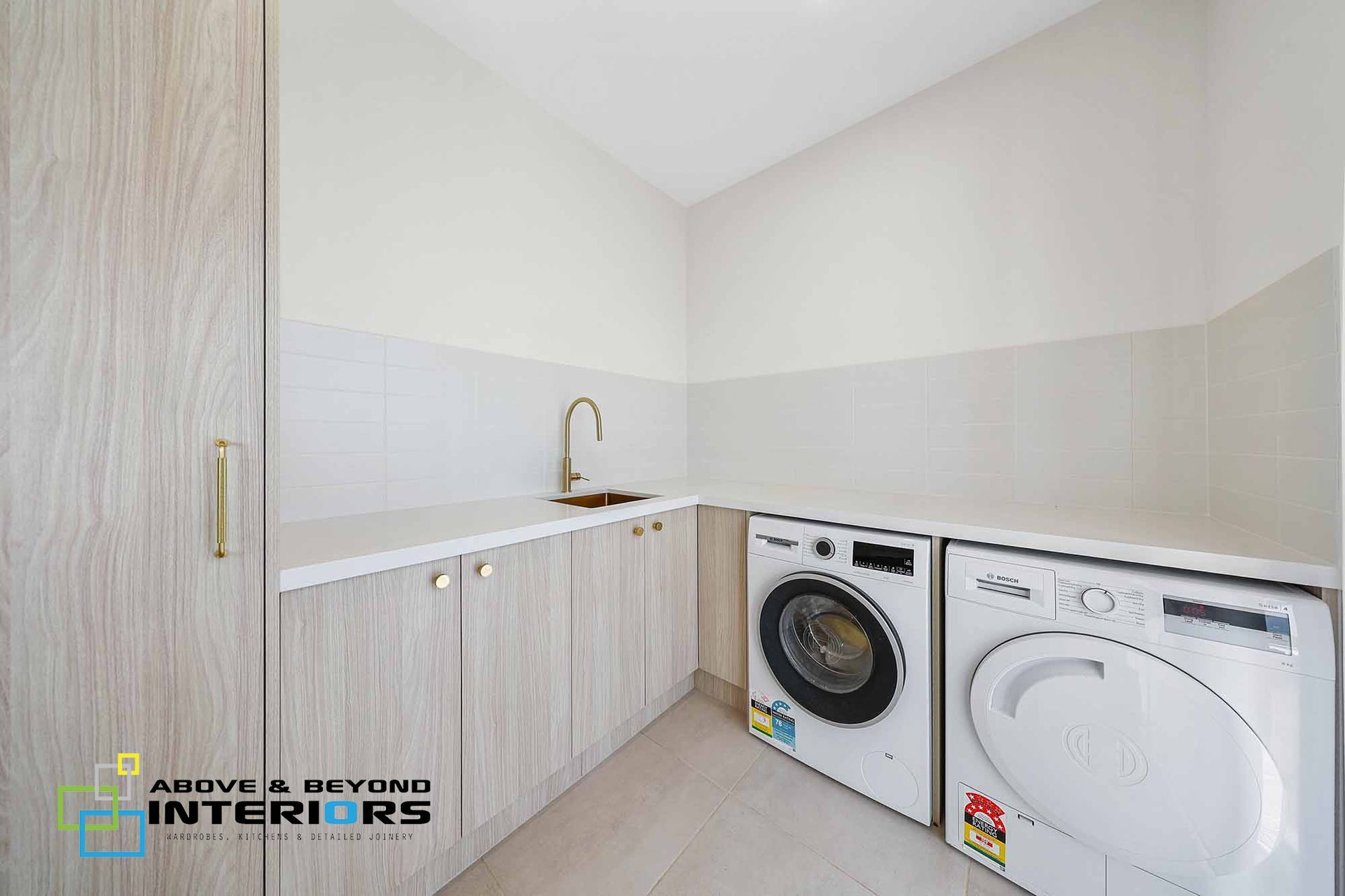 Bright Laundry Room with White Cabinets, Sink — Above & Beyond Interiors in Smeaton Grange, NSW