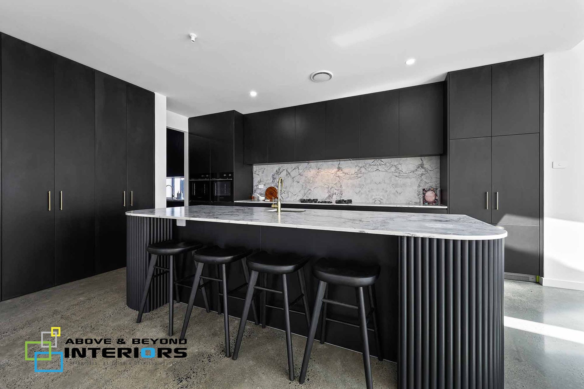 Modern Black Kitchen with Bar Stools, and Marble Backsplash — Above & Beyond Interiors in Smeaton Grange, NSW