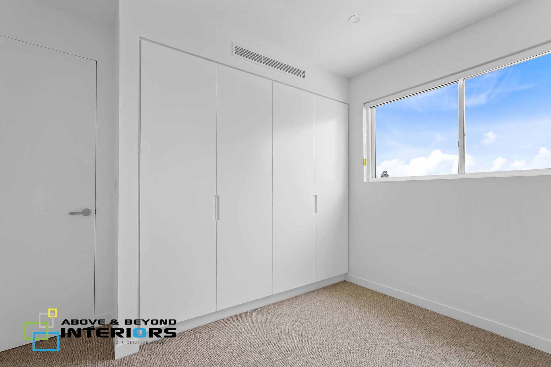 Empty White Bedroom with Built-In Closets — Above & Beyond Interiors in Smeaton Grange, NSW