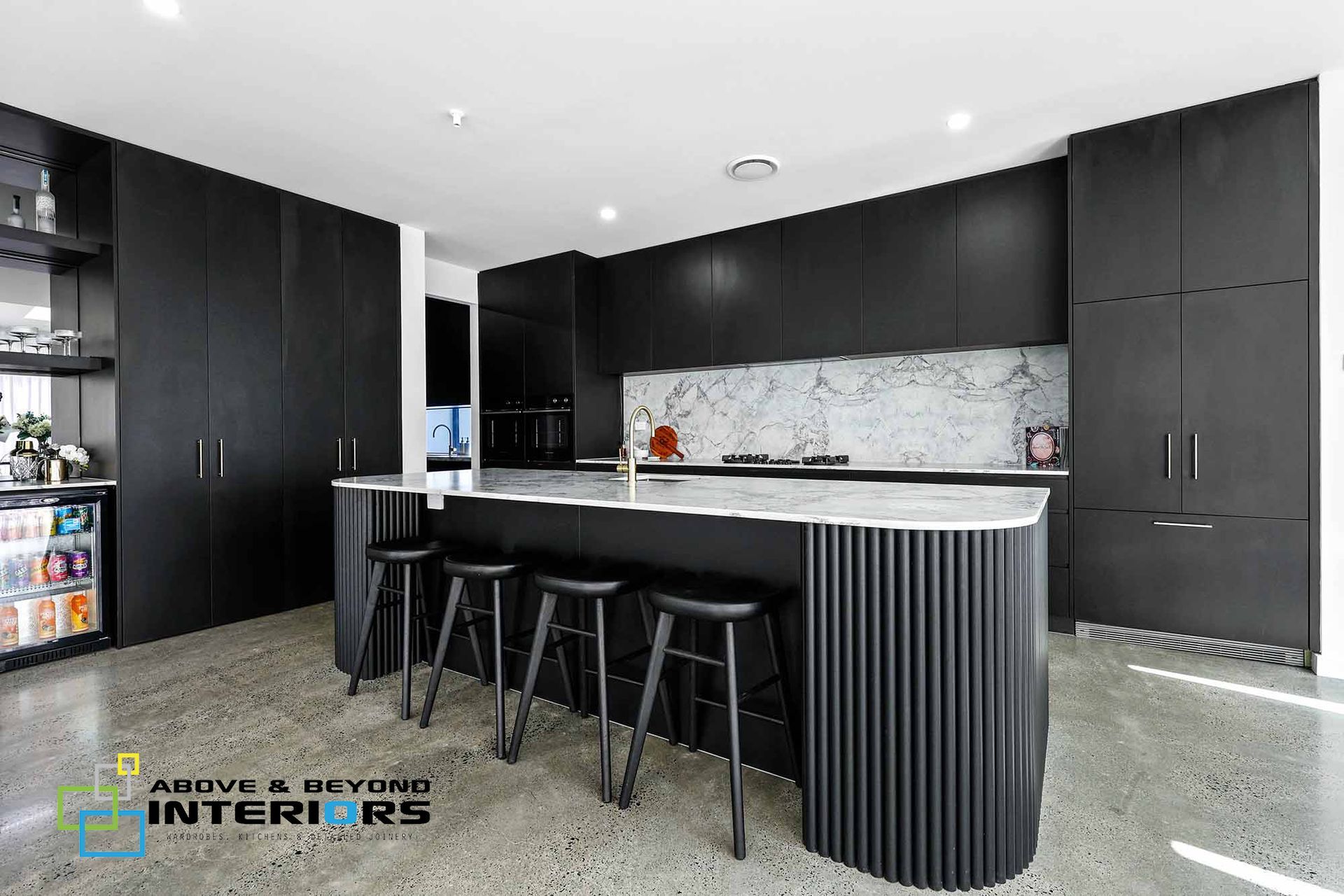 Modern Black Kitchen with Bar Stools  — Above & Beyond Interiors in Smeaton Grange, NSW