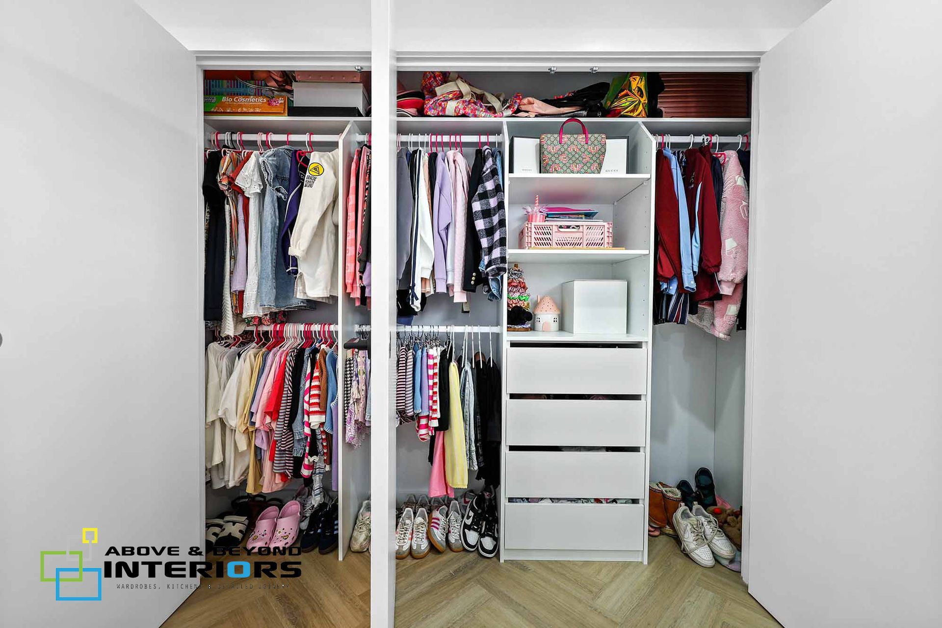 Open Closet with Hanging Clothes — Above & Beyond Interiors in Smeaton Grange, NSW