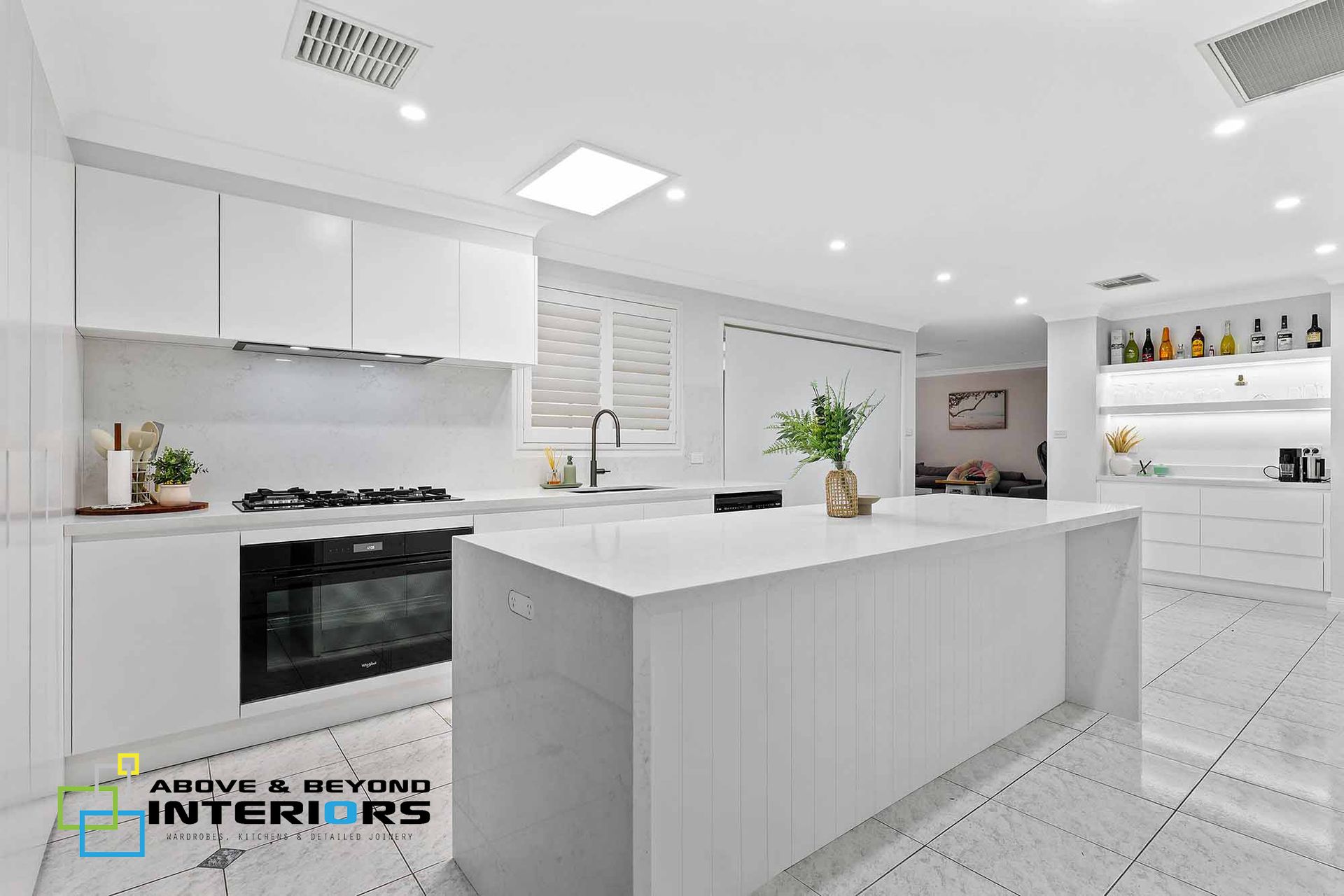Bright White Modern Kitchen with Black Stove — Above & Beyond Interiors in Smeaton Grange, NSW