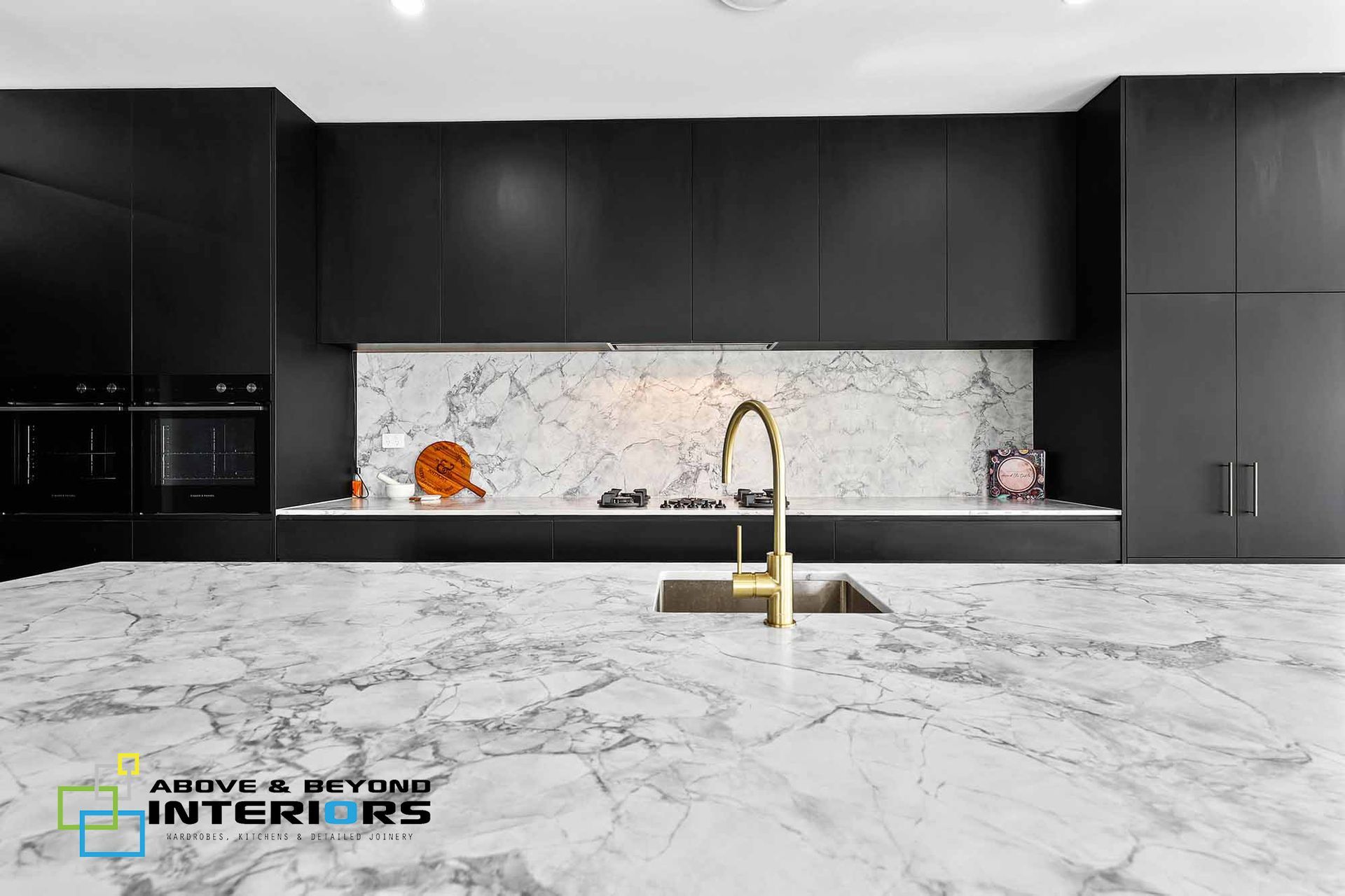 Modern Kitchen with Black Cabinets, and Gold Faucet — Above & Beyond Interiors in Smeaton Grange, NSW