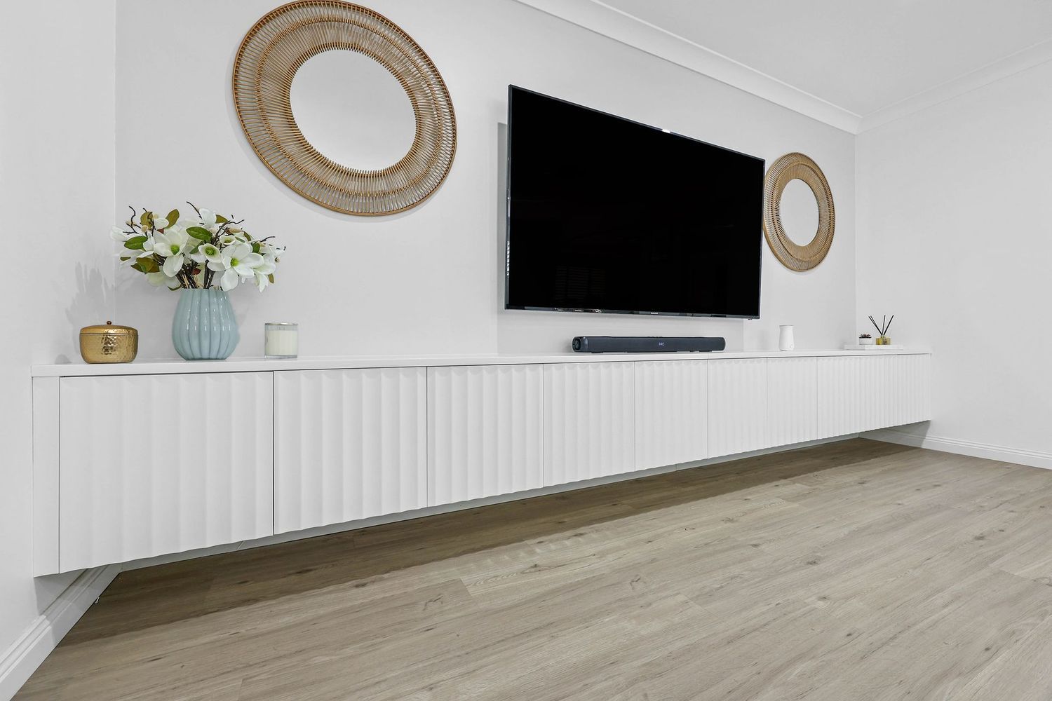 Modern Living Room With Wall-mounted TV — Above & Beyond Interiors in Smeaton Grange, NSW