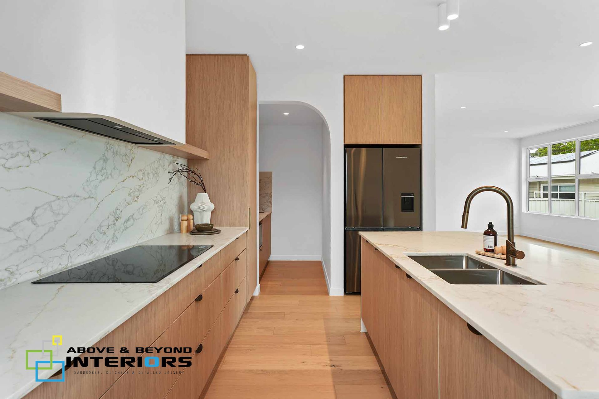 Modern White Kitchen with Marble Countertops — Above & Beyond Interiors in Smeaton Grange, NSW