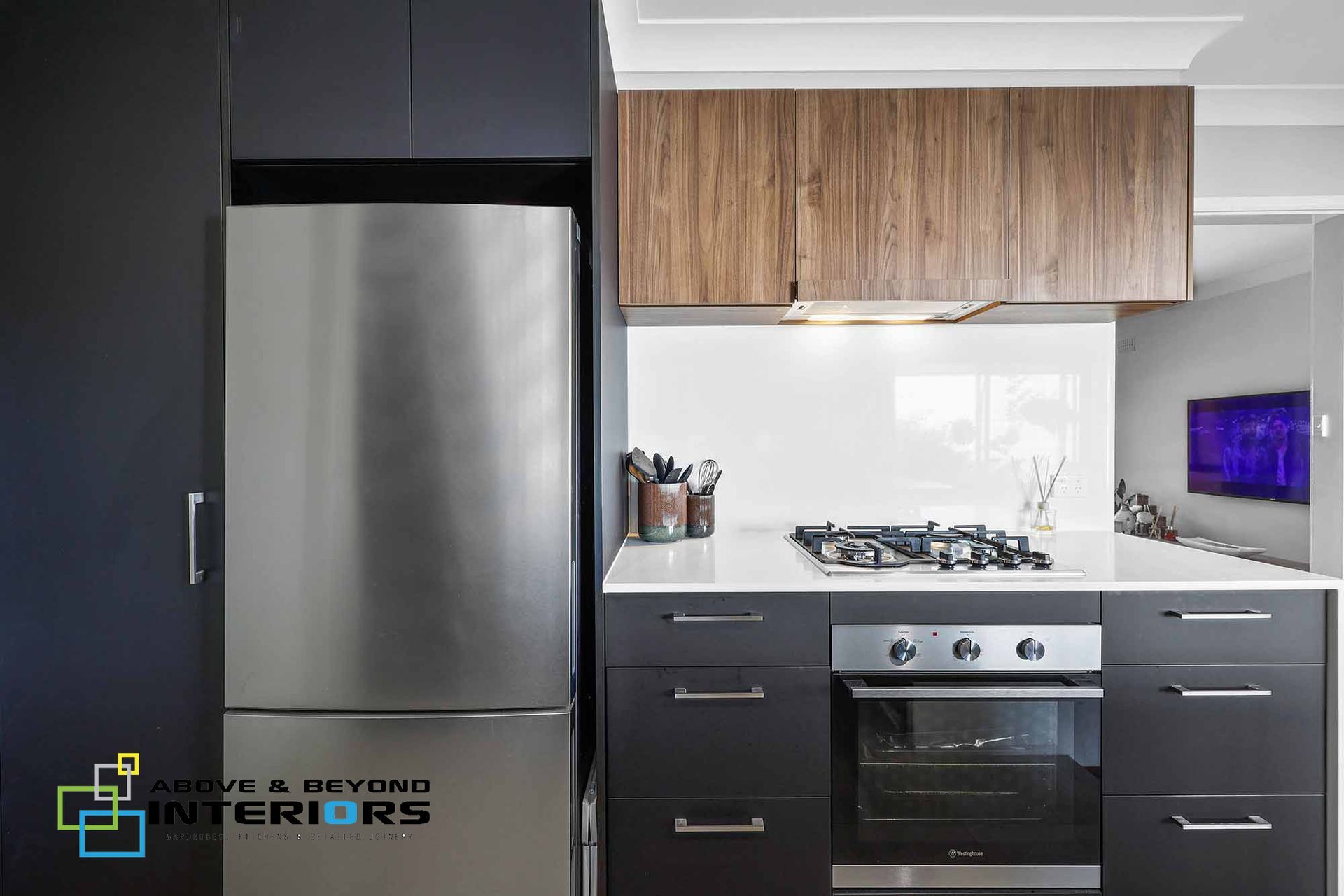 Modern Kitchen with Stainless Steel Fridge — Above & Beyond Interiors in Smeaton Grange, NSW