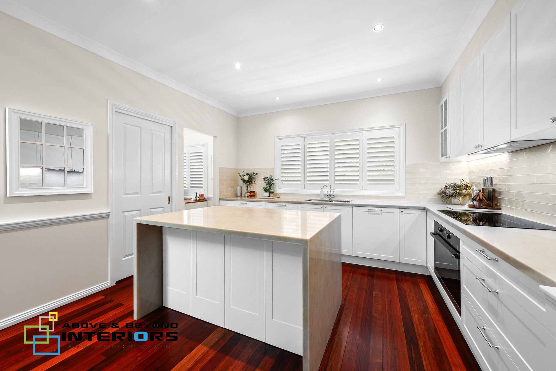 Bright Modern Kitchen with Central Island, and Dark Wood Floors — Above & Beyond Interiors in Smeaton Grange, NSW