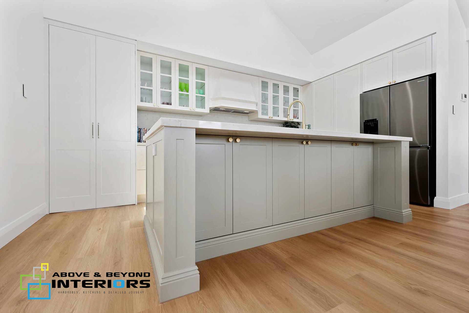 Bright White Modern Kitchen with Island and Pendant Lights — Above & Beyond Interiors in Smeaton Grange, NSW