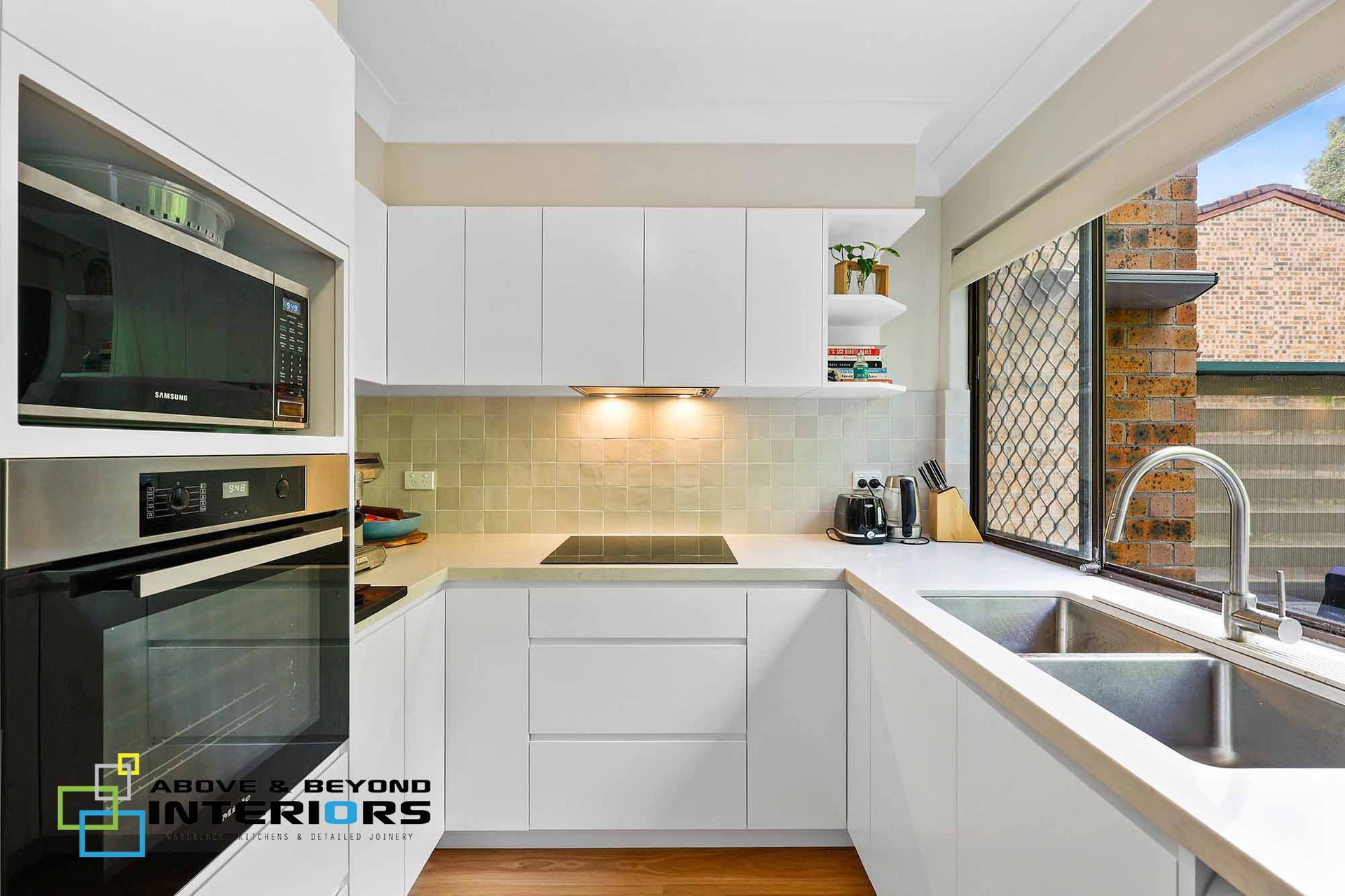 Bright Modern Kitchen with White Cabinets — Above & Beyond Interiors in Smeaton Grange, NSW