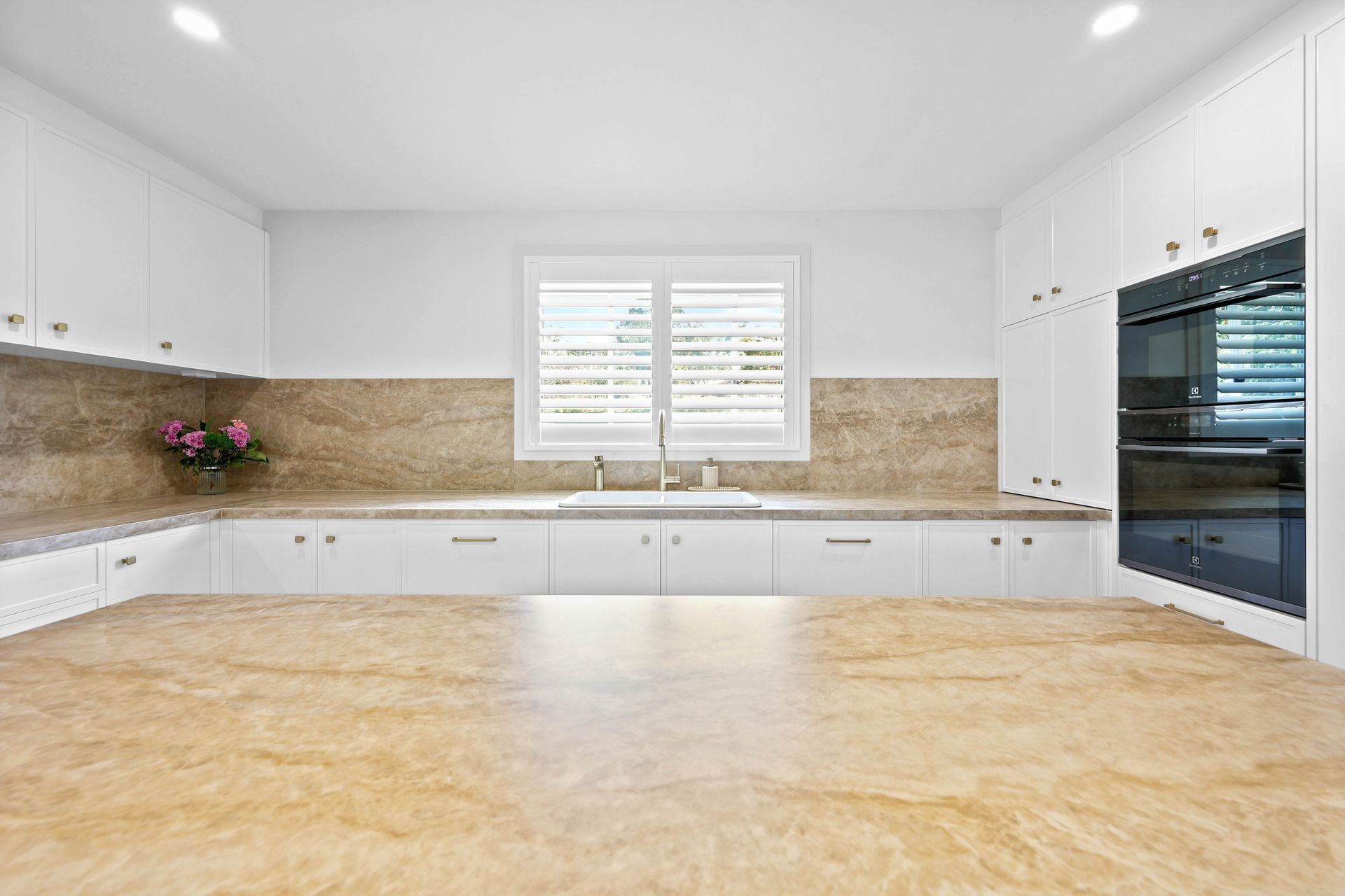 Bright Modern Kitchen With White Cabinets — Above & Beyond Interiors in Smeaton Grange, NSW