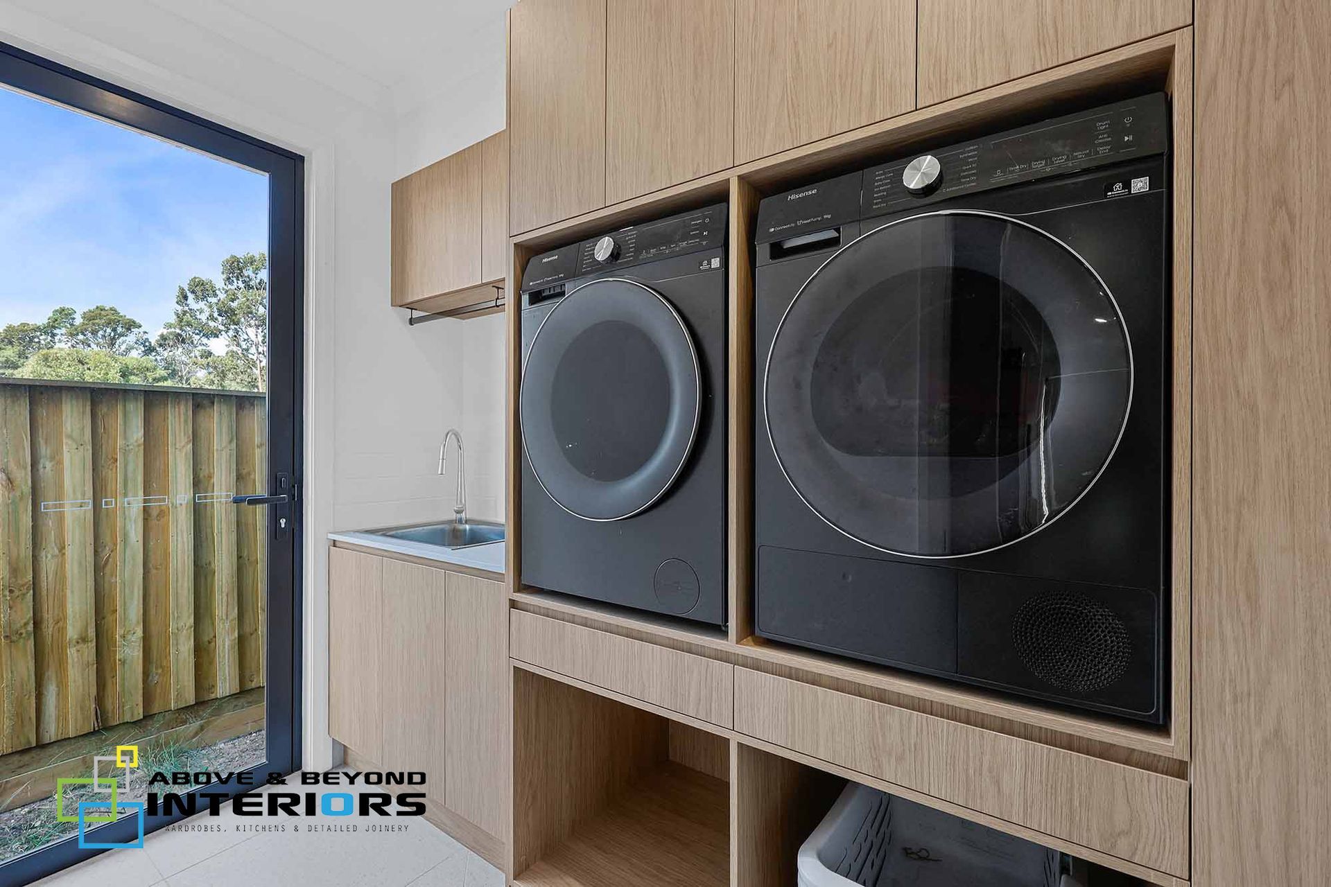 Modern Laundry Room with Front-Loading Washer — Above & Beyond Interiors in Smeaton Grange, NSW
