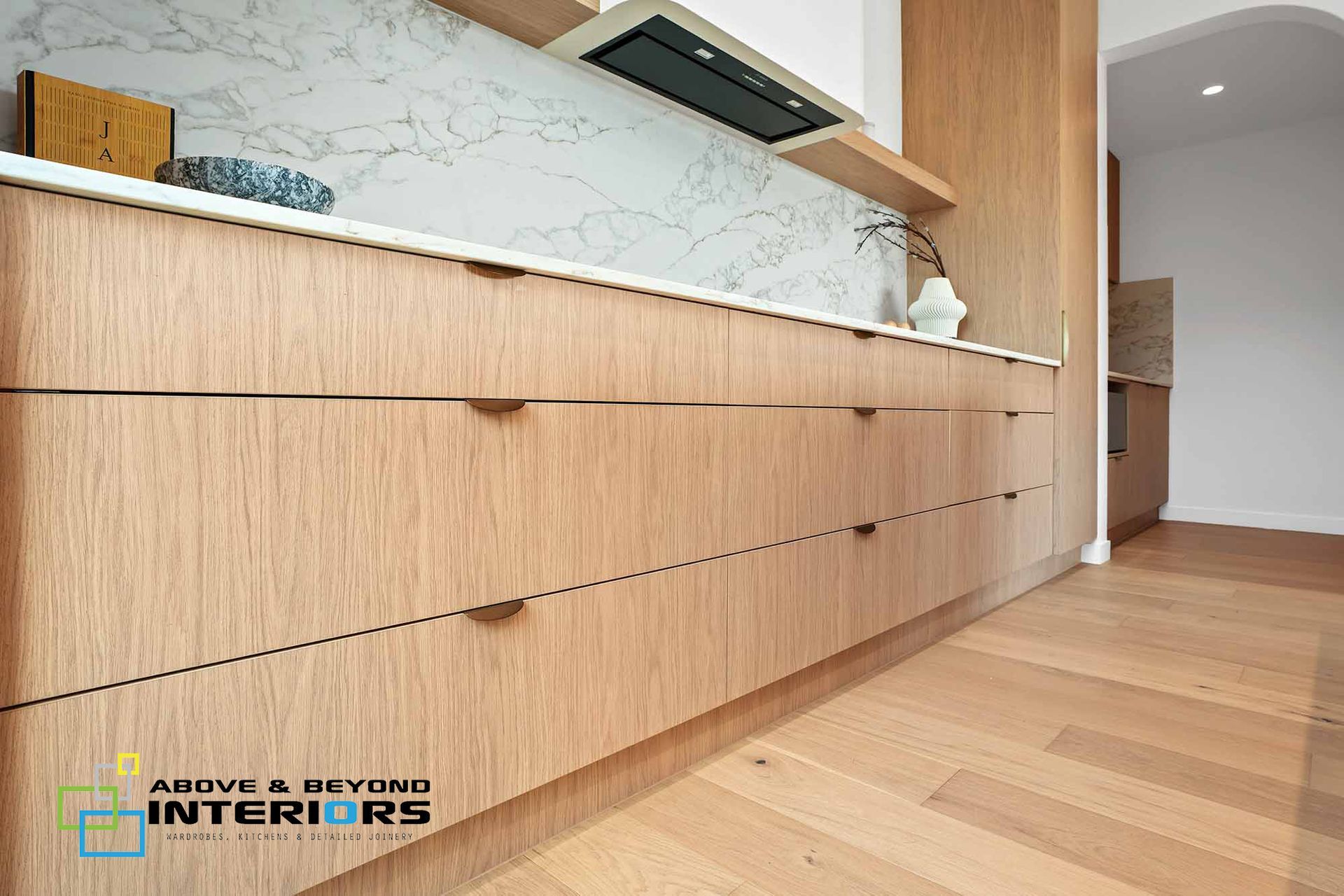 Modern Kitchen with Light Wood Cabinets — Above & Beyond Interiors in Smeaton Grange, NSW