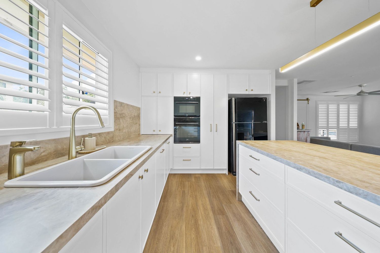 Bright Modern Kitchen With White Cabinets — Above & Beyond Interiors in Smeaton Grange, NSW