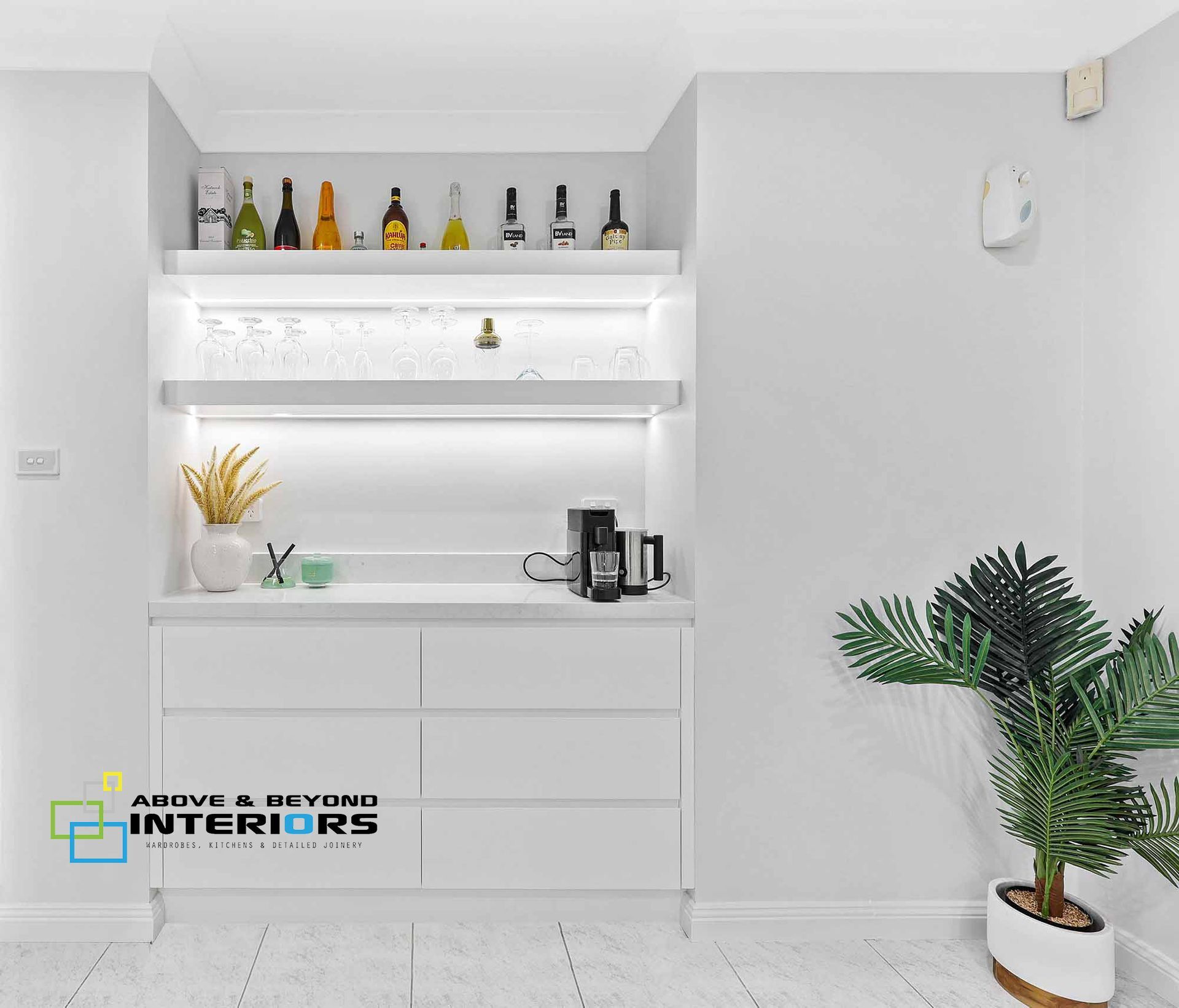 Minimal White Bar Nook with Shelves, and Bottles — Above & Beyond Interiors in Smeaton Grange, NSW