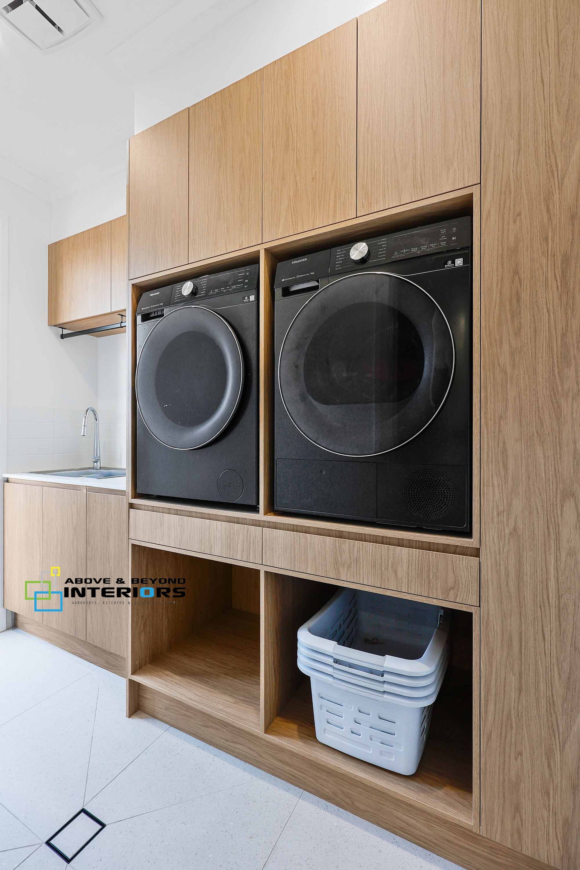 Built-In Wooden Laundry Cabinet with Stacked Washer — Above & Beyond Interiors in Smeaton Grange, NSW