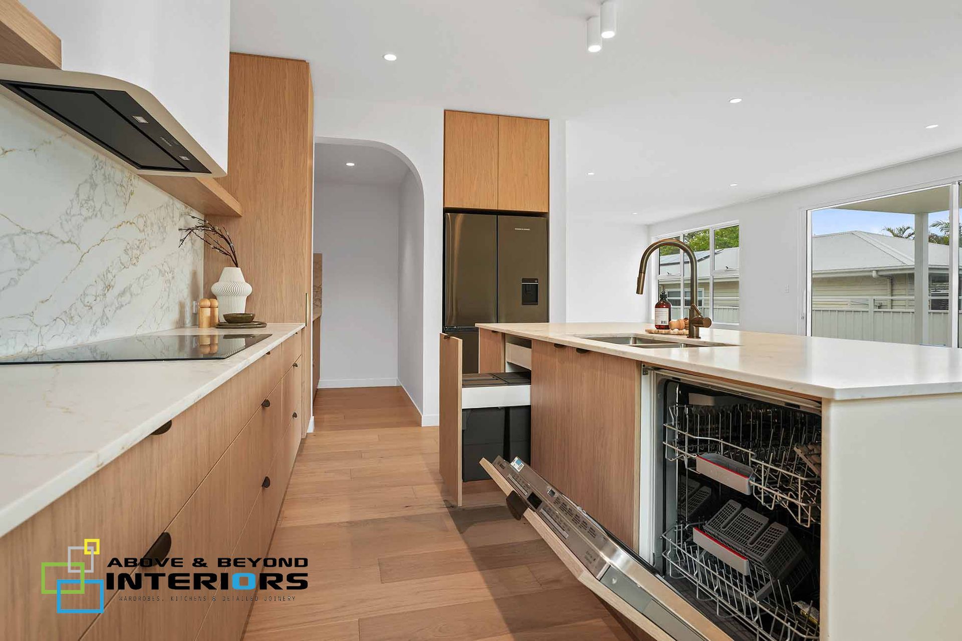 Modern Kitchen with White Counters, and Wood Cabinets — Above & Beyond Interiors in Smeaton Grange, NSW