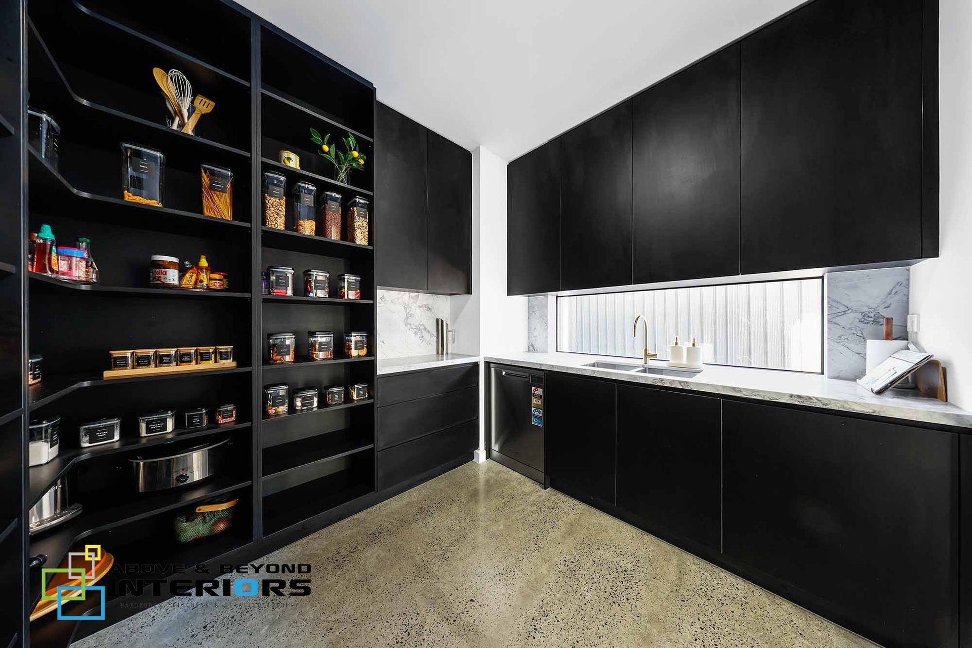 Modern Black-And-White Kitchen with Tall Pantry Shelves — Above & Beyond Interiors in Smeaton Grange, NSW
