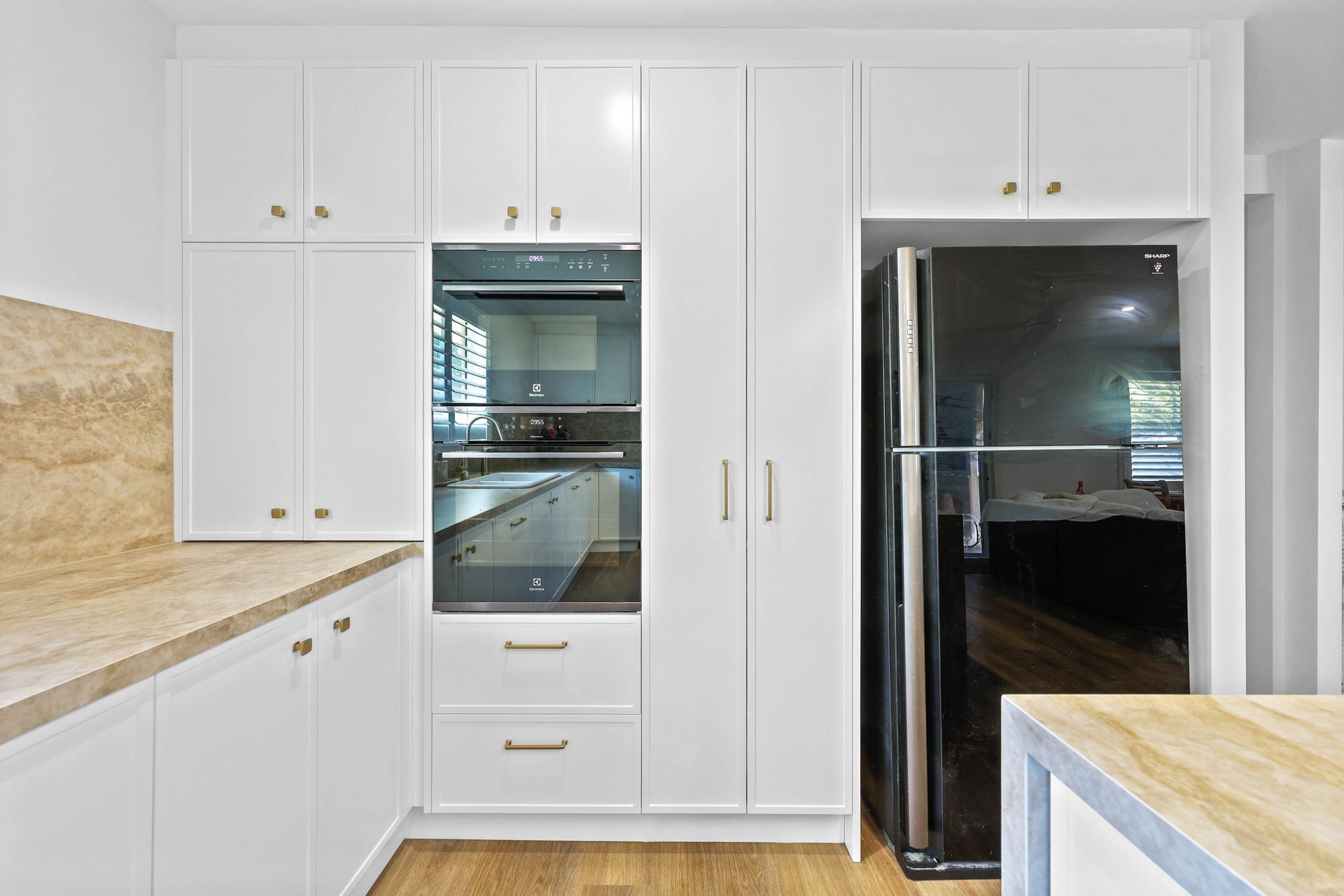 Bright White Kitchen With Built-in Oven, Cabinets — Above & Beyond Interiors in Smeaton Grange, NSW